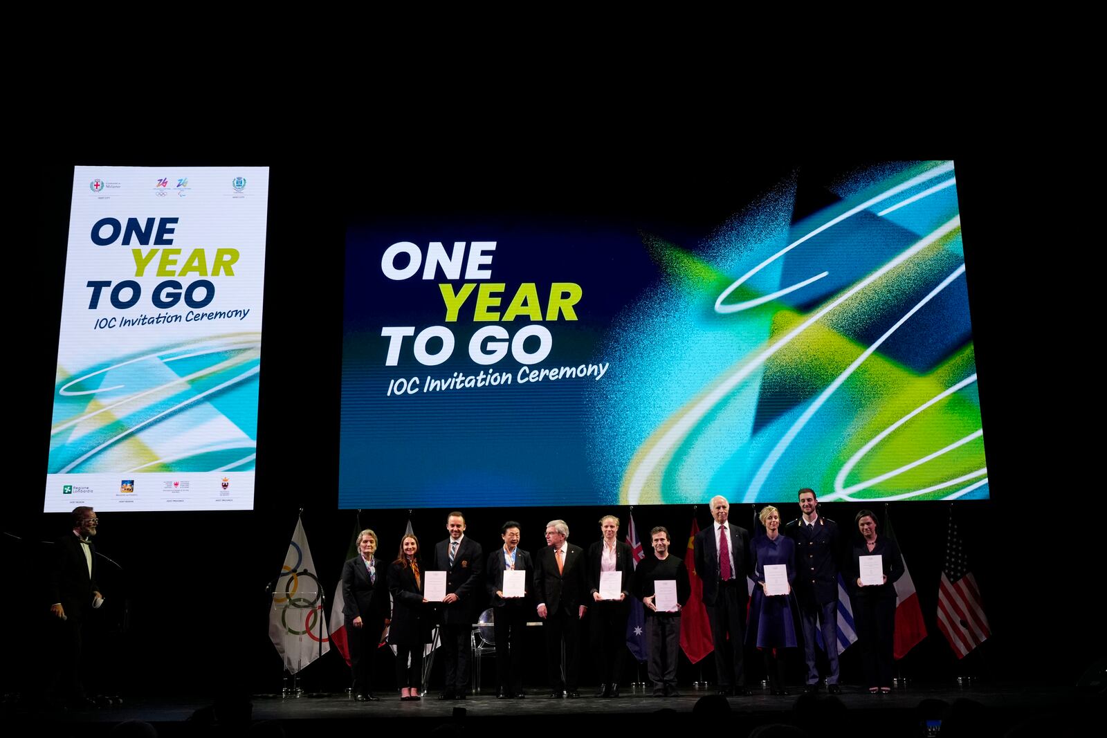 Members of the Olympic committees attend the ceremony 'One Year To Go' for the 2026 Milano-Cortina Winter Olympics, at the Strehler Theatre, in Milan, Thursday, Feb. 6, 2025. (AP Photo/Luca Bruno)