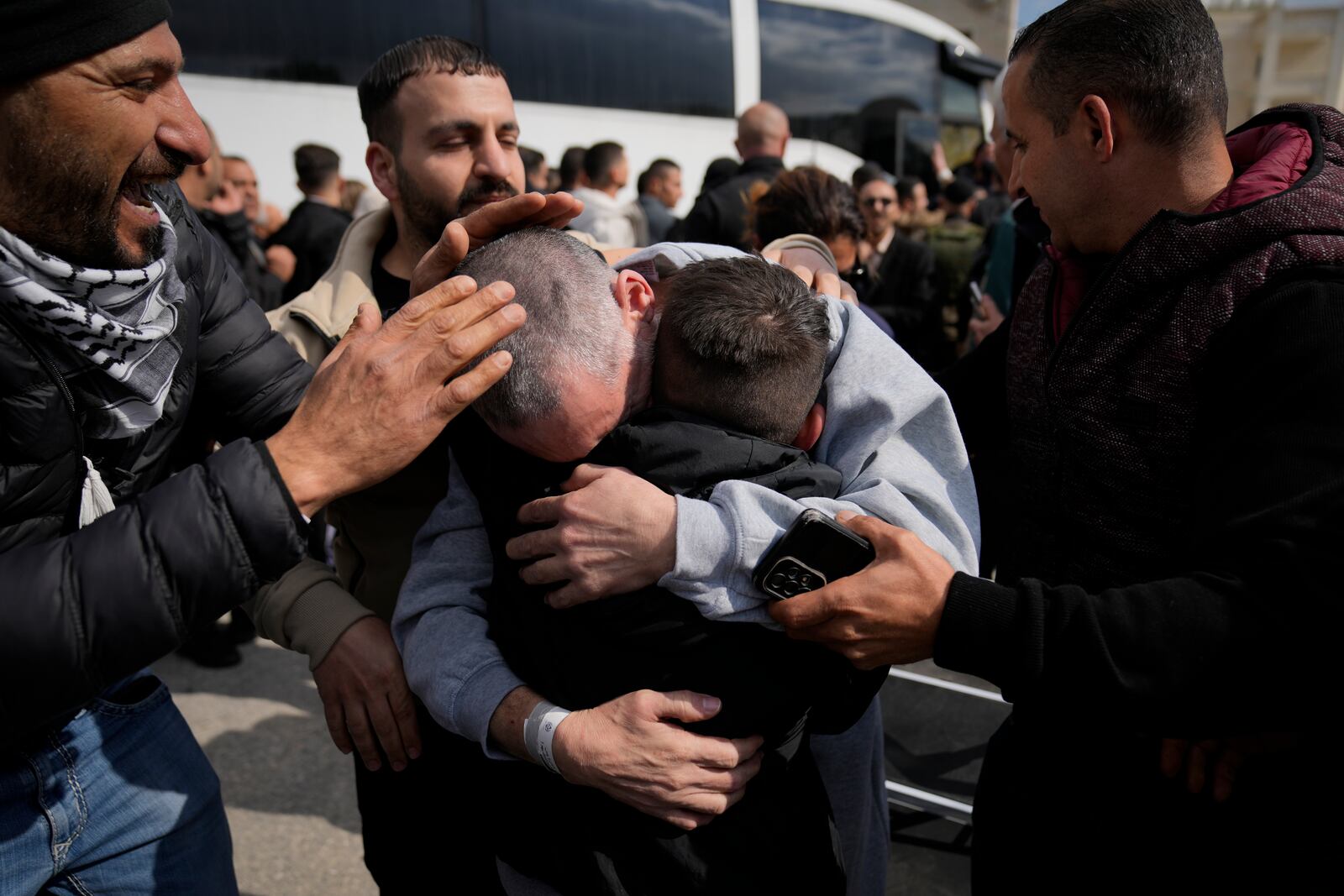 Palestinian prisoners are greeted as they exit a Red Cross bus after being released from Israeli prison following a ceasefire agreement between Israel and Hamas, in the West Bank city of Ramallah, Saturday Feb. 1, 2025. (AP Photo/Nasser Nasser)