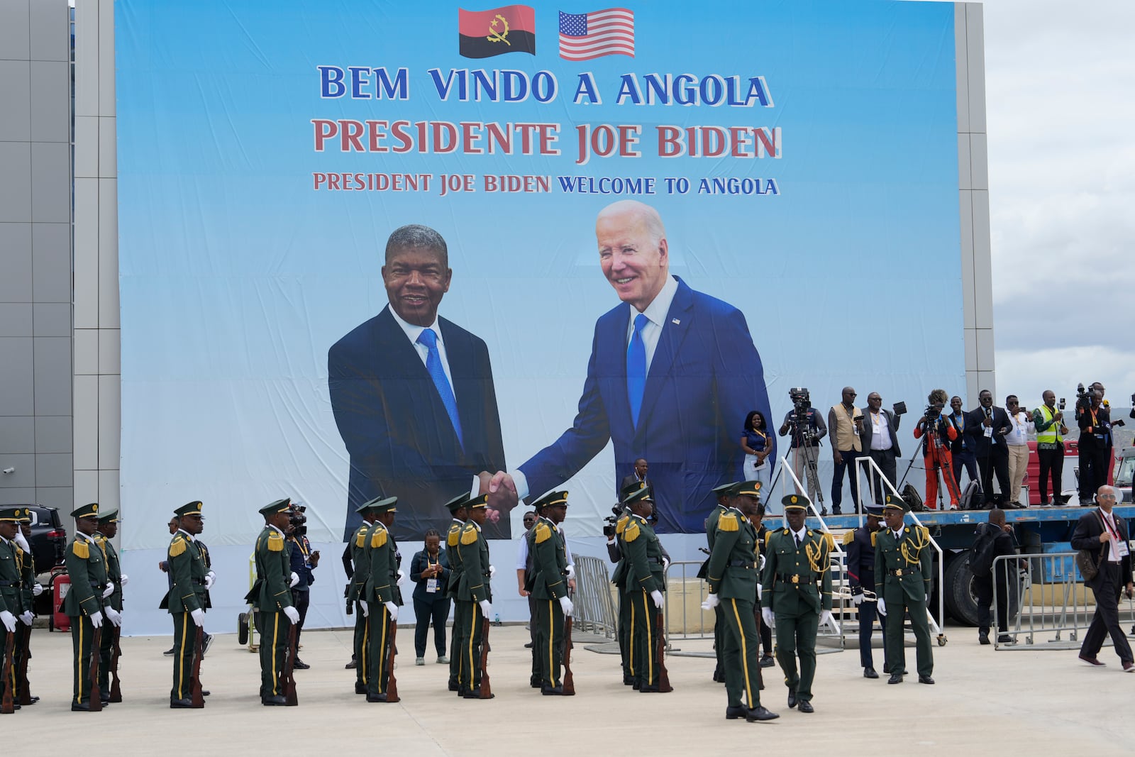 A poster showing President Joe Biden and Angola's President Joao Lourenco is seen during a welcome ceremony at Catumbela airport in Angola on Wednesday, Dec. 4, 2024. (AP Photo/Ben Curtis)