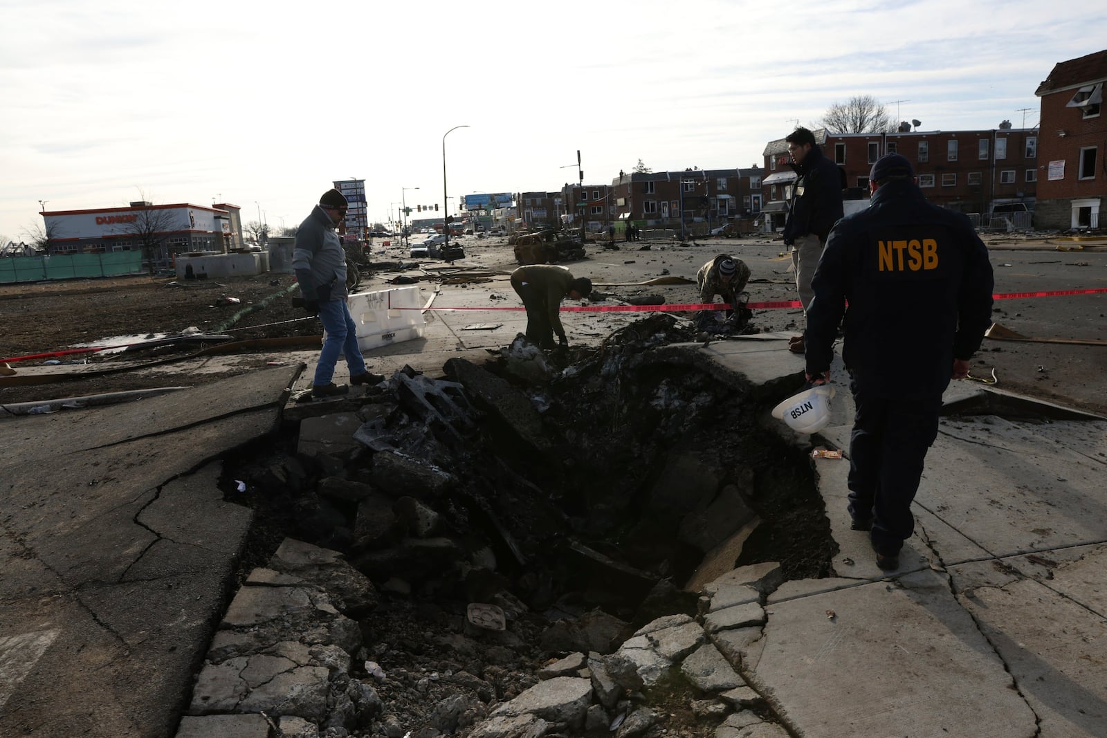 This image released by the NTSB on Tuesday, Feb. 4, 2025 shows the site of initial impact of the Learjet 55 that crashed on Jan. 31 in Philadelphia. (NTSB via AP)