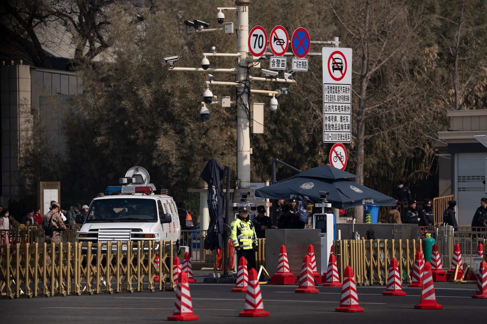 A police officer stands on duty near a road block near the Great Hall of the People ahead of the National People's Congress in Beijing, on Feb. 28, 2025. (AP Photo/Ng Han Guan)