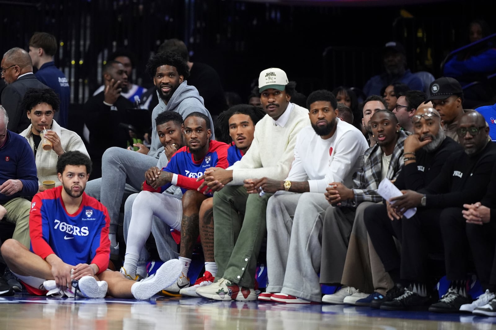 Philadelphia 76ers' Jared McCain, from left, Alex Reese, Joel Embiid, Justin Edwards, Oshae Brissett, Jalen Hood-Schifino, Andre Drummond, Paul George, Tyrese Maxey and Kyle Lowry watch from the bench during the second half of an NBA basketball game against the Indiana Pacers Friday, March 14, 2025, in Philadelphia. (AP Photo/Matt Slocum)