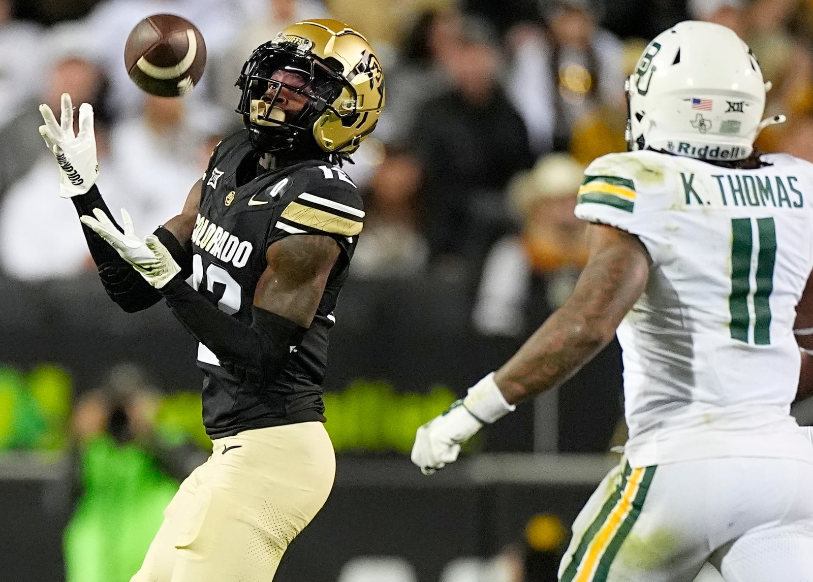 FILE - Colorado wide receiver Travis Hunter, left, pulls in a pass ahead of Baylor linebacker Keaton Thomas during the second half of an NCAA college football game Saturday, Sept. 21, 2024, in Boulder, Colo. (AP Photo/David Zalubowski, File)