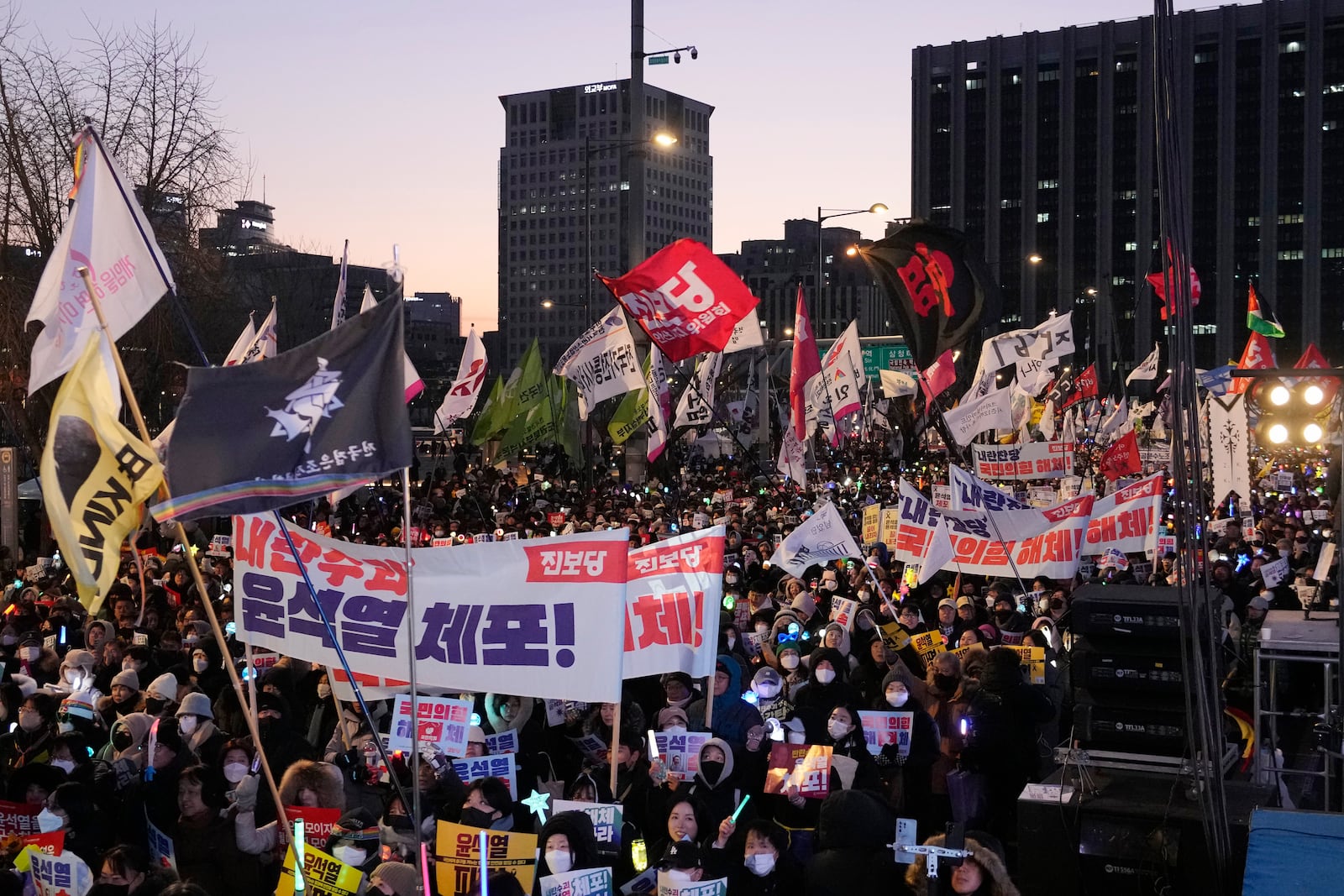 Protesters march during a rally demanding the arrest of impeached South Korean President Yoon Suk Yeol in Seoul, South Korea, Saturday, Jan. 11, 2025. Banners read: "Arrest Yoon Suk Yeol." (AP Photo/Ahn Young-joon)