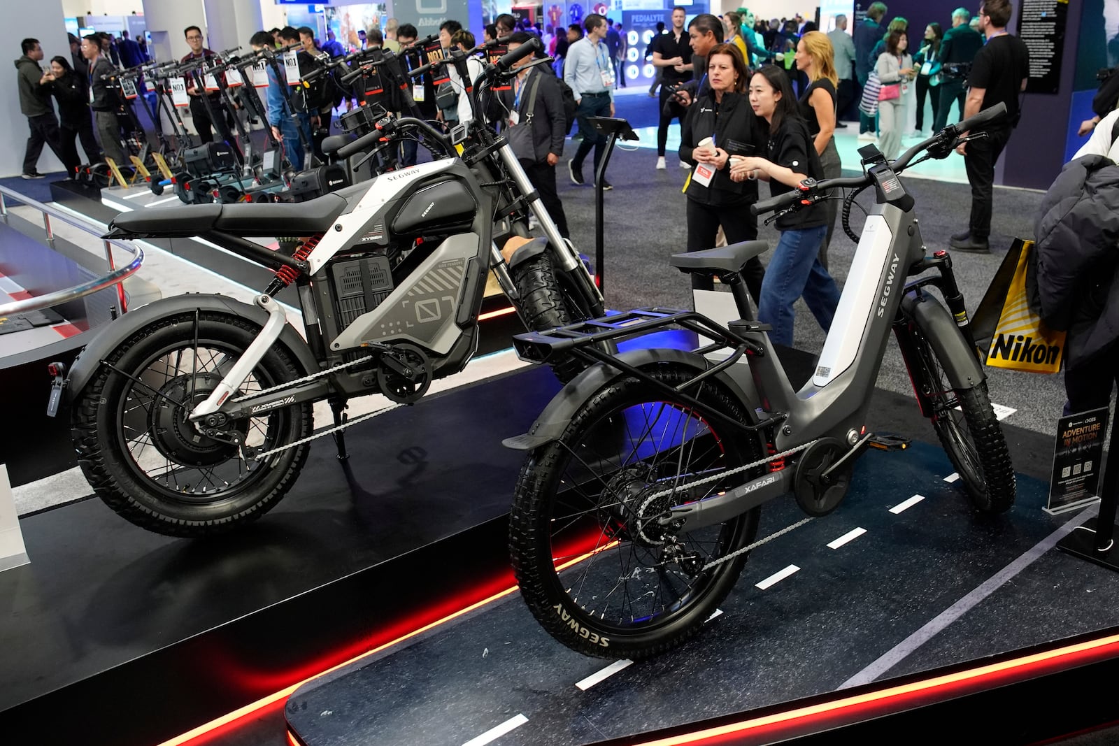 The Segway Xafari, right and Xyber e-bikes sit on display during the CES tech show Tuesday, Jan. 7, 2025, in Las Vegas. (AP Photo/John Locher)