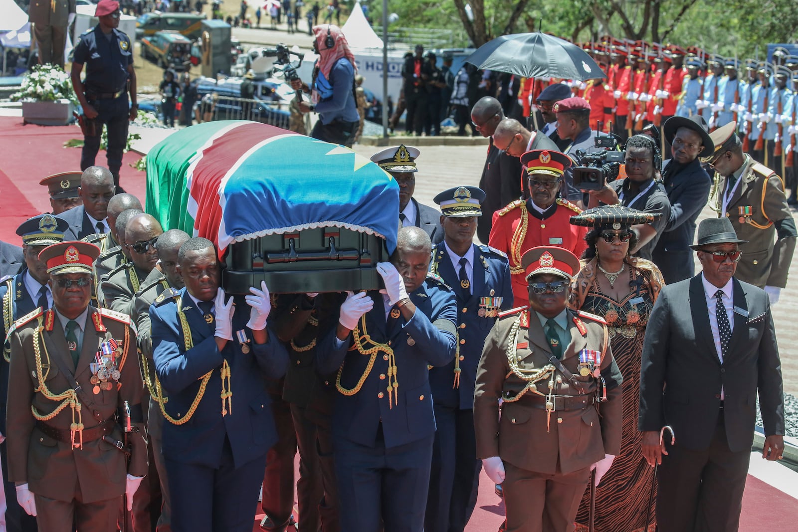 Pall-bearers carry the casket containing the remains of Namibia's founding president Sam Nujoma during his state funeral at Heroes' Acre in Windhoek, Namibia, Saturday, March 1, 2025. (AP Photo/Dirk Heinrich)