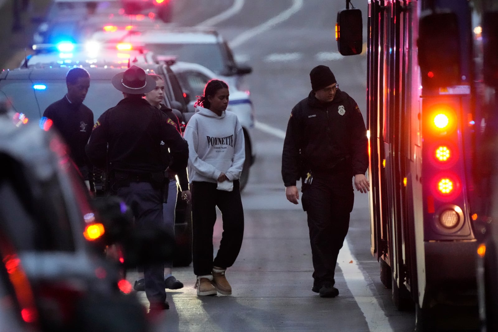 Students aboard a bus as they leave the shelter following a shooting at the Abundant Life Christian School, Monday, Dec. 16, 2024. (AP Photo/Morry Gash)