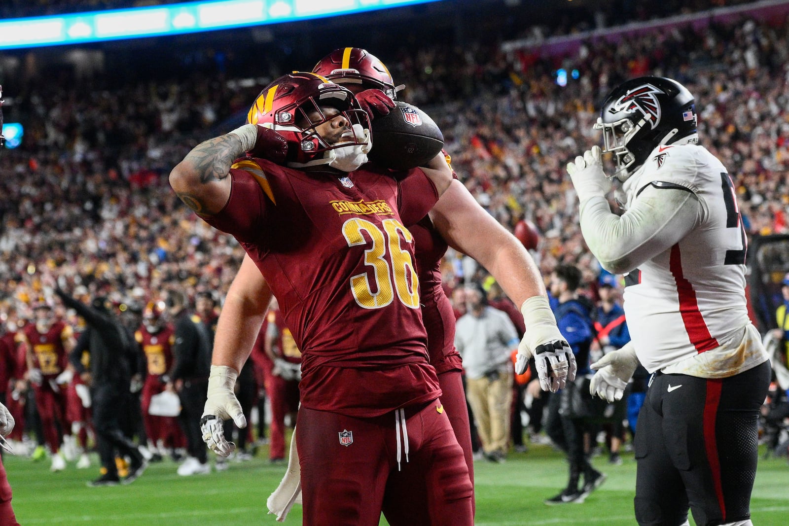 ]Washington Commanders running back Chris Rodriguez Jr. (36) celebrates his touchdown during the second half of an NFL football game against the Atlanta Falcons, Sunday, Dec. 29, 2024, in Landover, Md. (AP Photo/Nick Wass)