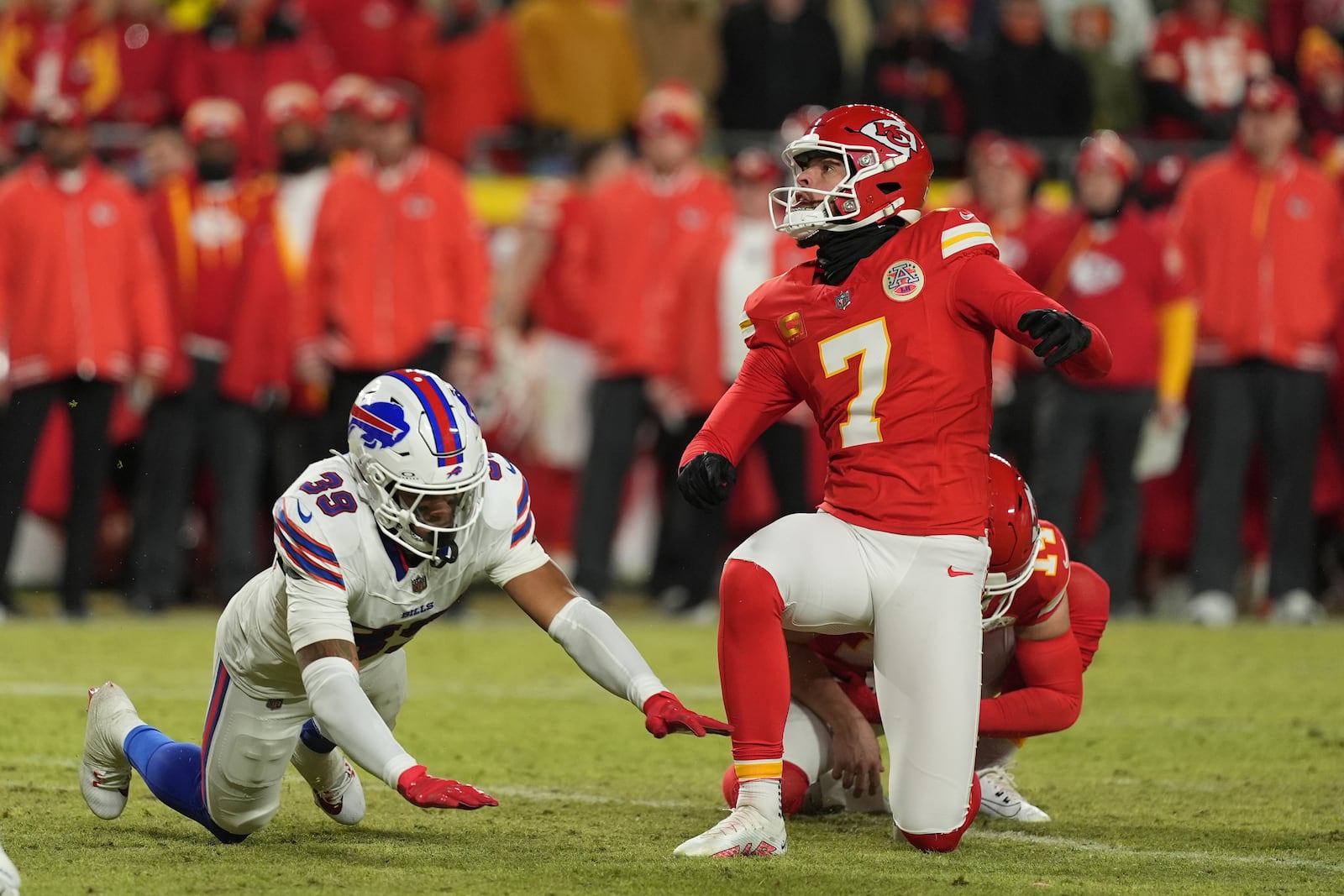 Kansas City Chiefs kicker Harrison Butker (7) watches his 35-yard field goal as Buffalo Bills' Cam Lewis (39) defends during the second half of the AFC Championship NFL football game, Sunday, Jan. 26, 2025, in Kansas City, Mo. (AP Photo/Charlie Riedel)