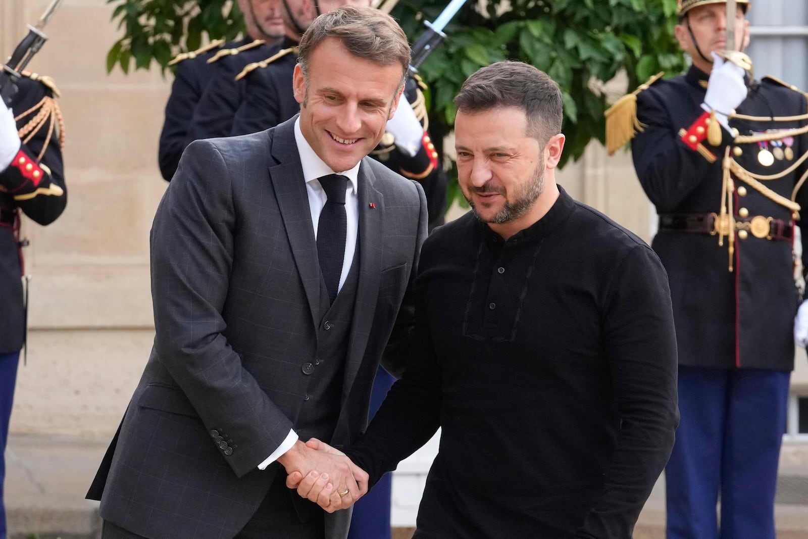 French President Emmanuel Macron, left, welcomes his Ukrainian counterpart Volodymyr Zelenskyy before a meeting at the Elysee Palace, in Paris, Thursday, Oct. 10, 2024. (AP Photo/Michel Euler)