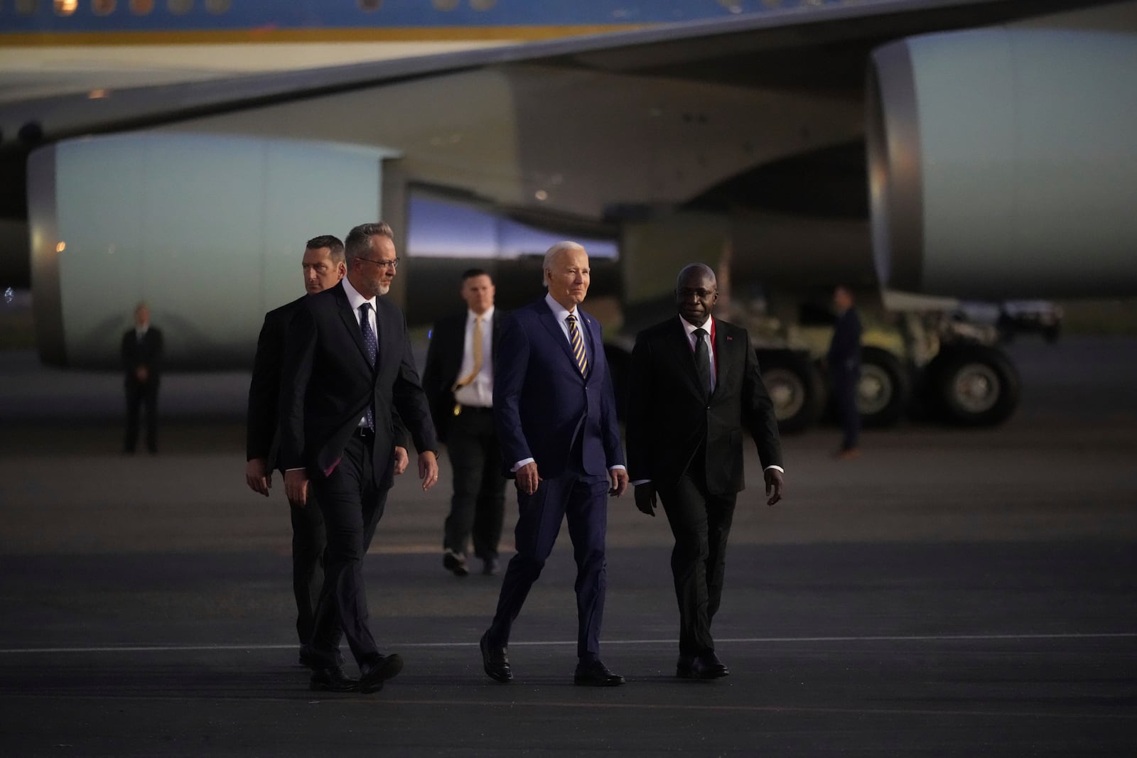 President Joe Biden is greeted by Angolan Foreign Minister Tete Antonio, right, as he arrives at Quatro de Fevereiro international airport in the capital Luanda, Angola on Monday, Dec. 2, 2024, on his long-promised visit to Africa. (AP Photo/Ben Curtis)