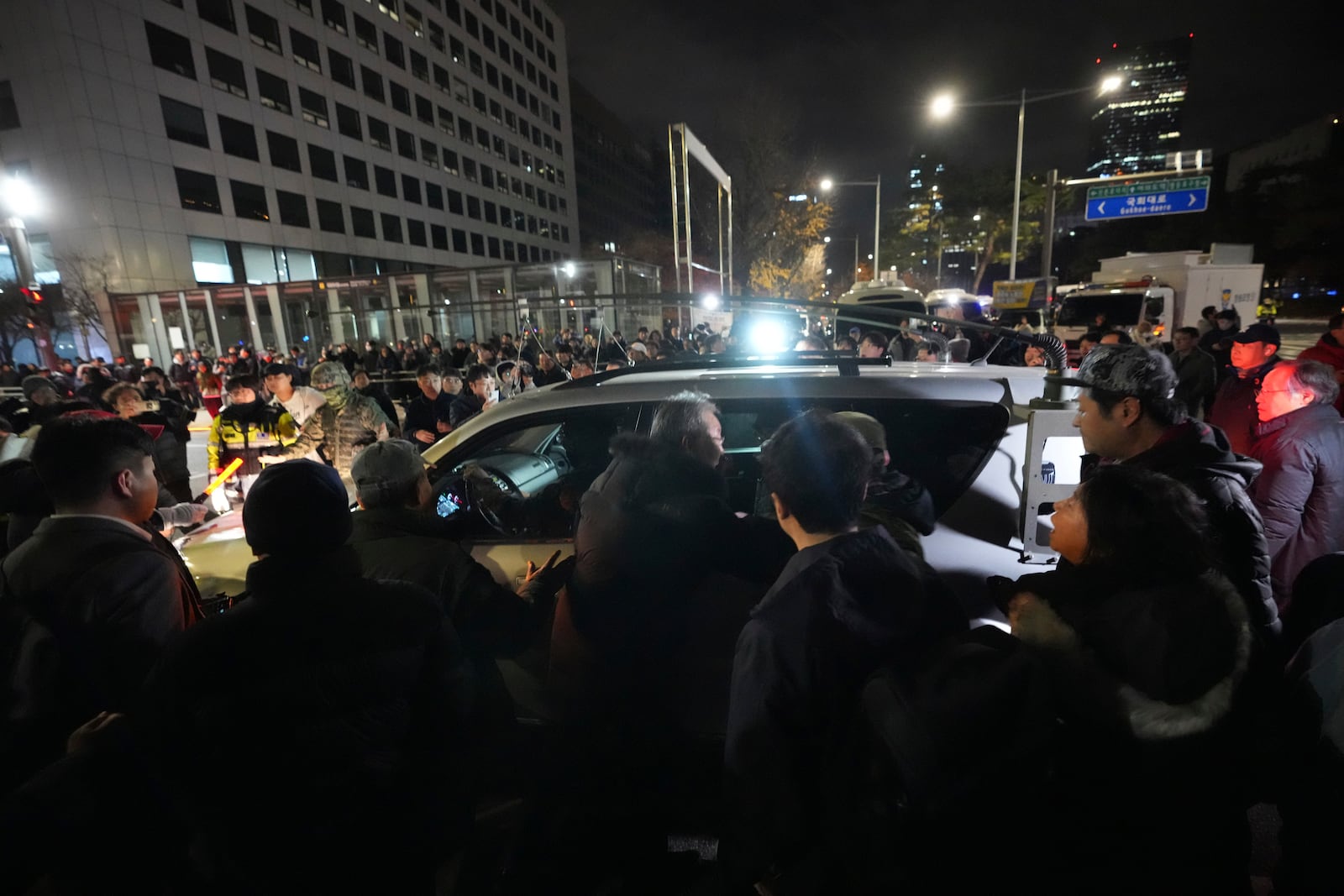 Military vehicles are surrounded by people outside the National Assembly in Seoul, South Korea, Wednesday, Dec. 4, 2024. (AP Photo/Lee Jin-man)