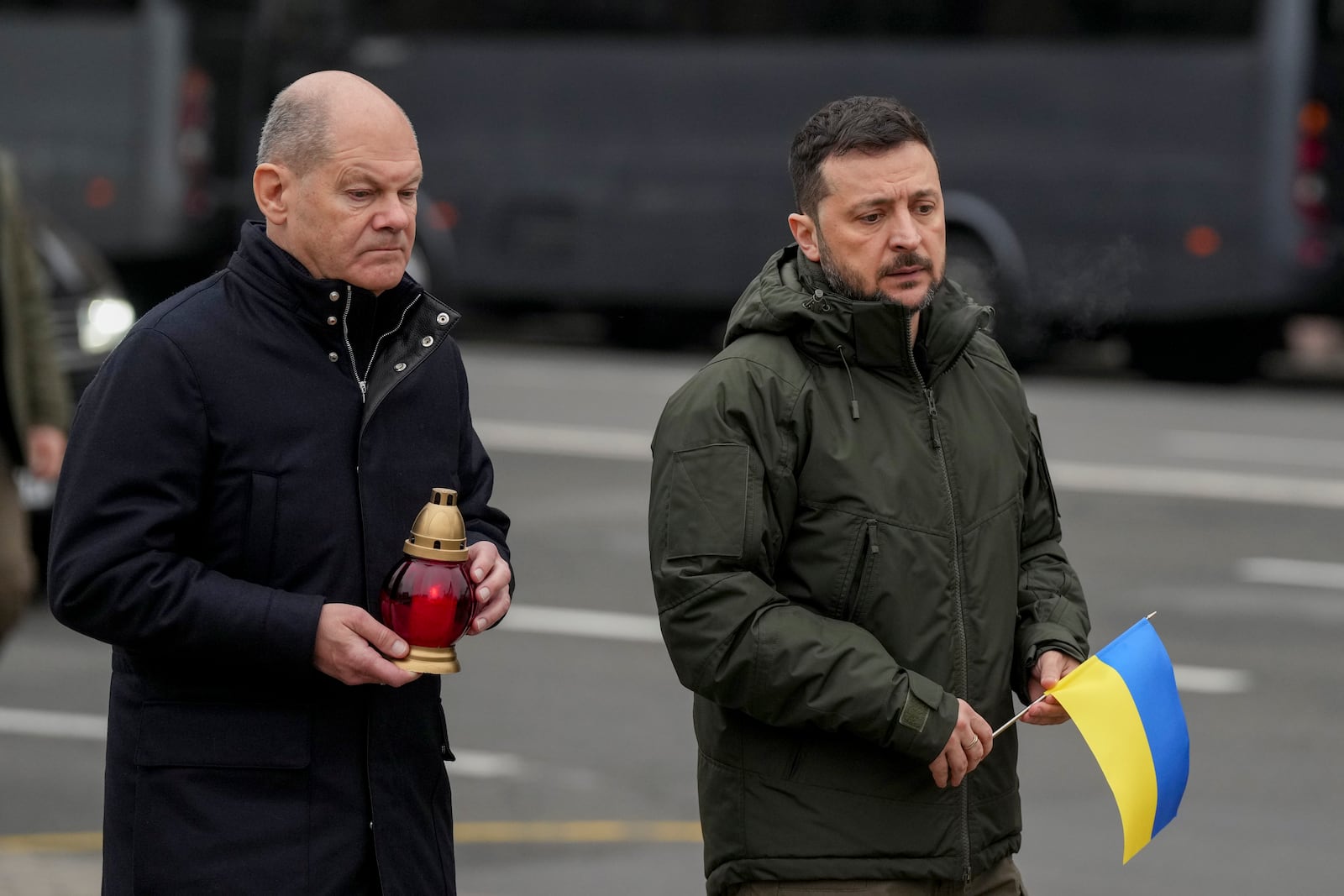 Ukraine's President Volodymyr Zelenskyy, right, and German Chancellor Olaf Scholz attend a ceremony of honoring fallen soldiers near the People's Memorial of National Memory in Kyiv, Ukraine, Monday, Dec.2, 2024. (AP Photo/Evgeniy Maloletka)