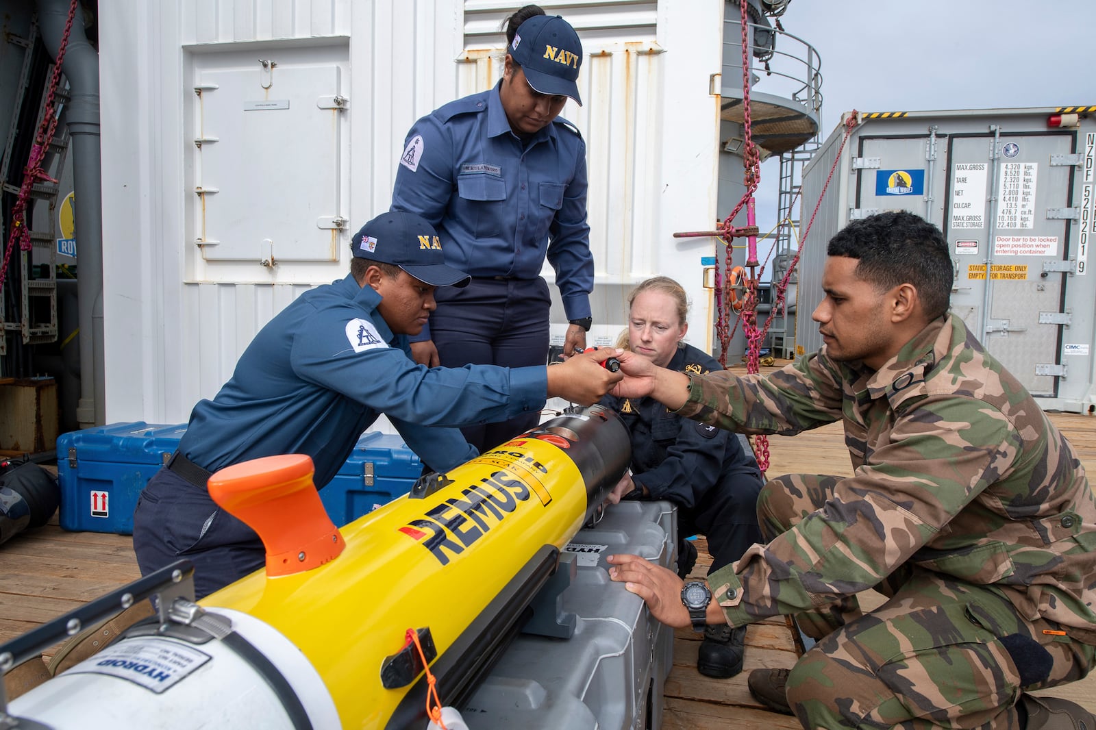 In this undated photo provided by New Zealand's Defence Public Affairs, hydrographers onboard HMNZS Manawanui prep REMUS ready for surveying in Tonga during Op Calypso. (Petty Officer Chris Weissenborn/Defence Public Affairs via AP)