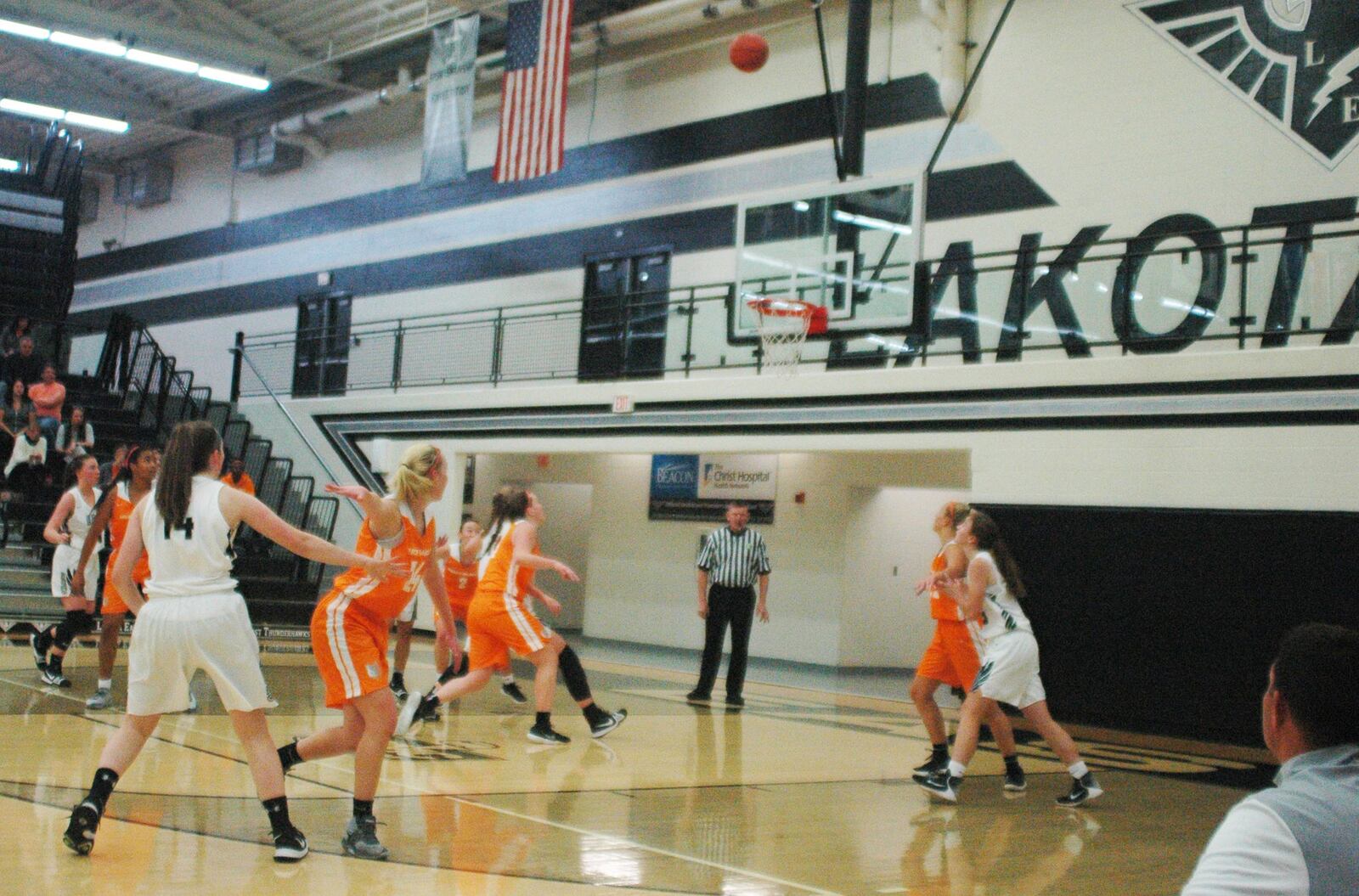 Everybody’s watching a 3-point attempt by Lakota East’s Logan Fox (14) during the Thunderhawks’ 48-26 loss to visiting Mercy McAuley on Saturday afternoon in Liberty Township. RICK CASSANO/STAFF