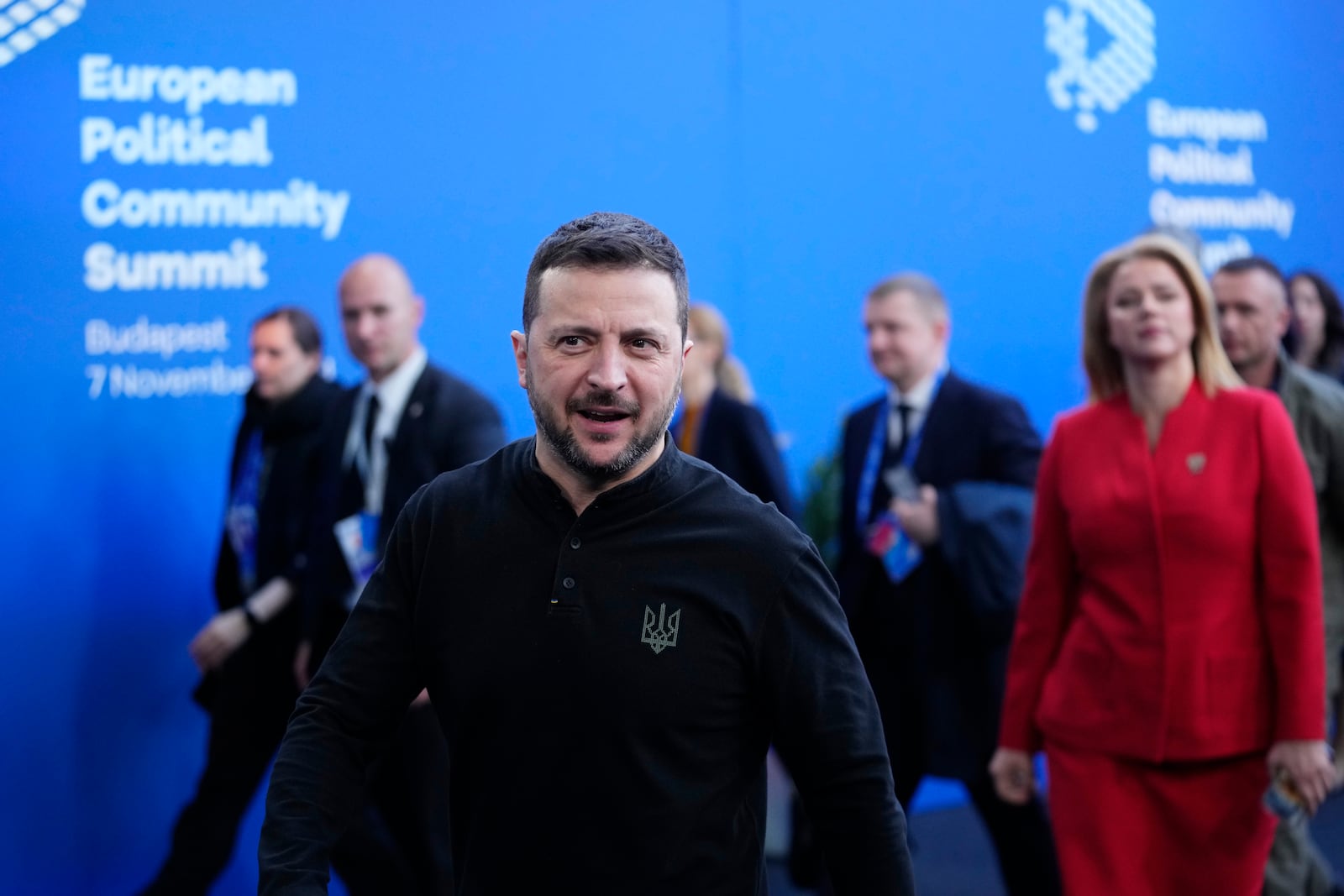 Ukraine's President Volodymyr Zelenskyy, center, and Latvia's Prime Minister Evika Silina, right, arrive for the European Political Community (EPC) Summit at the Puskas Arena in Budapest, Hungary, Thursday, Nov. 7, 2024. (AP Photo/Petr Josek)