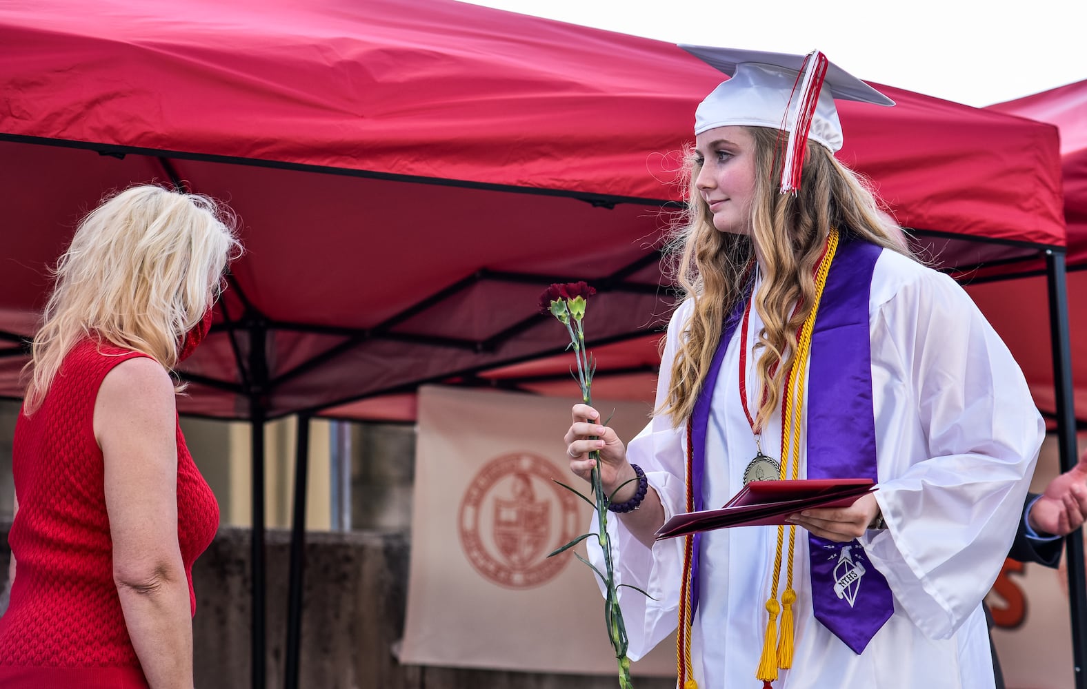 Madison High School drive-thru graduation ceremony at Land of Illusion