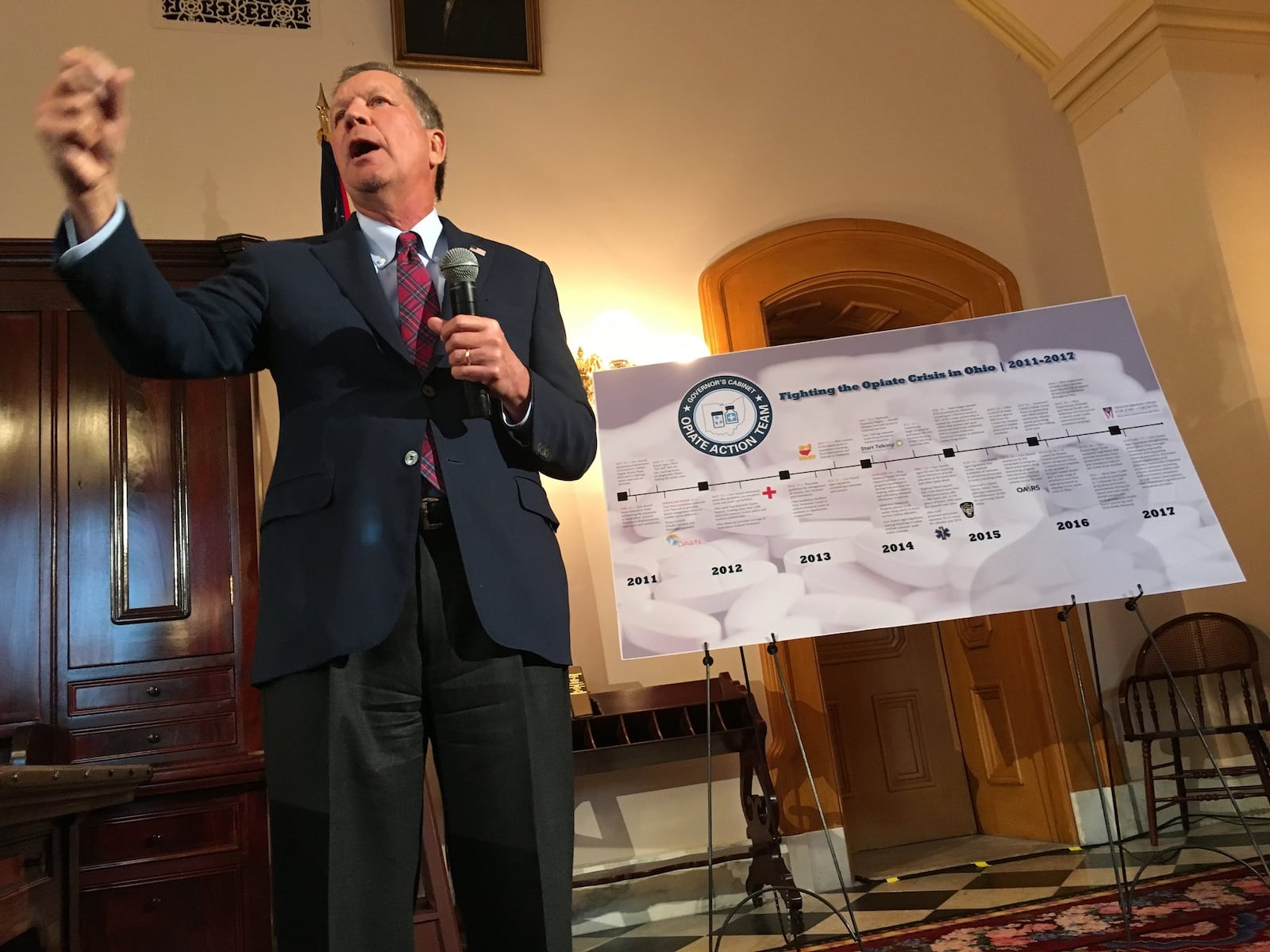 Gov. John Kasich signs a stack of bills on Jan. 4, 2017, including some major changes to fighting heroin addiction.. Photo by Laura Bischoff