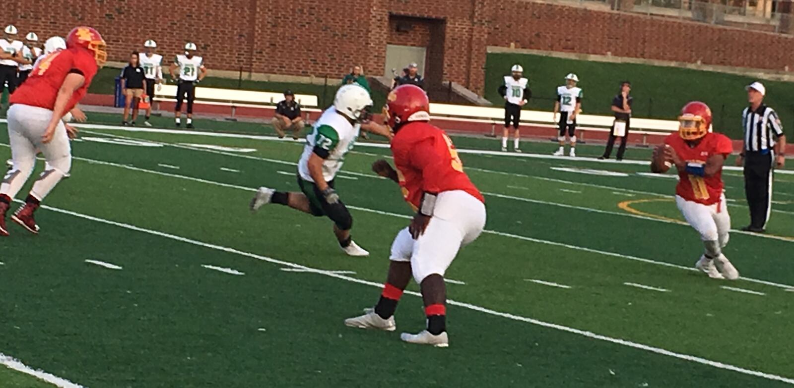 Badin’s Bryce Holian (72) is in pursuit of Purcell Marian quarterback Mitch Mayes during the Rams’ 42-12 win on Sept. 16, 2017, at Walnut Hills’ Marx Stadium. RICK CASSANO/STAFF