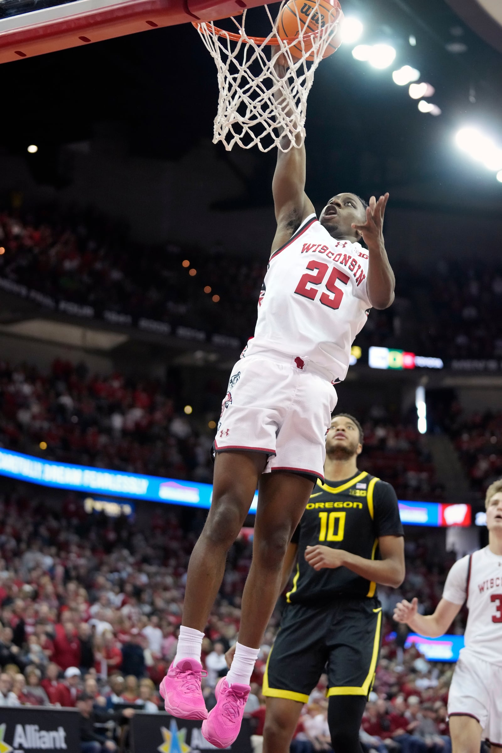 Wisconsin guard John Blackwell (25) scores over Oregon forward Kwame Evans Jr. (10) during overtime of an NCAA college basketball game Saturday, Feb. 22, 2025, in Madison, Wis. (AP Photo/Kayla Wolf)