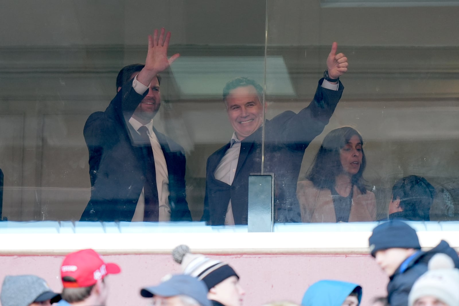 Vice President-elect JD Vance, from left, and Senator-elect Dave McCormick, R-Pa., gesture to the crowd as Usha Vance looks on at the NCAA college football game between Army and Navy at Northwest Stadium in Landover, Md., Saturday, Dec. 14, 2024. (AP Photo/Stephanie Scarbrough)