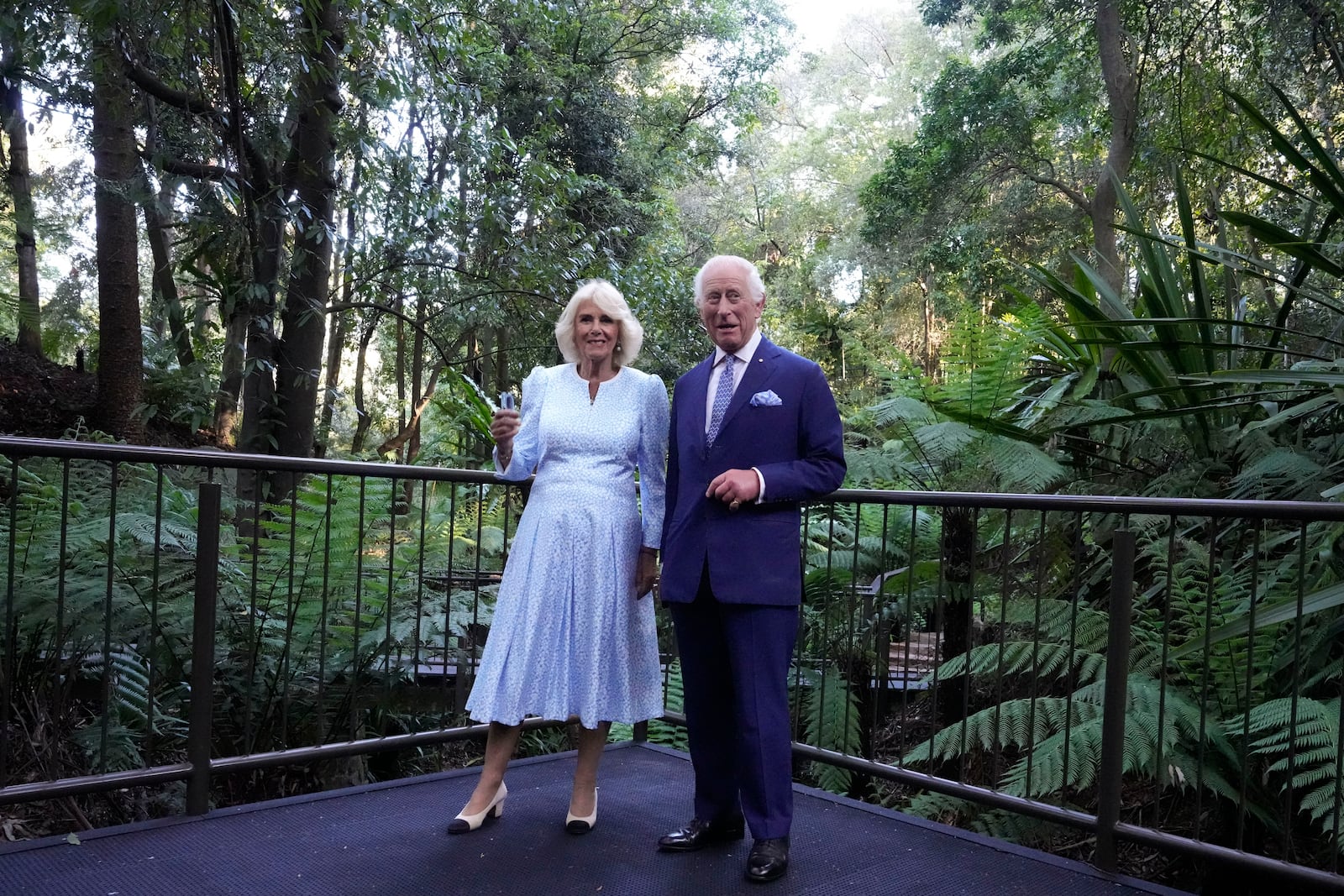 Britain's King Charles III, and Queen Camilla, chats as they walk through the Rainforest Gully at the Australian National Botanic Gardens in Canberra, Monday, Oct. 21, 2024. (AP Photo/Mark Baker, Pool)