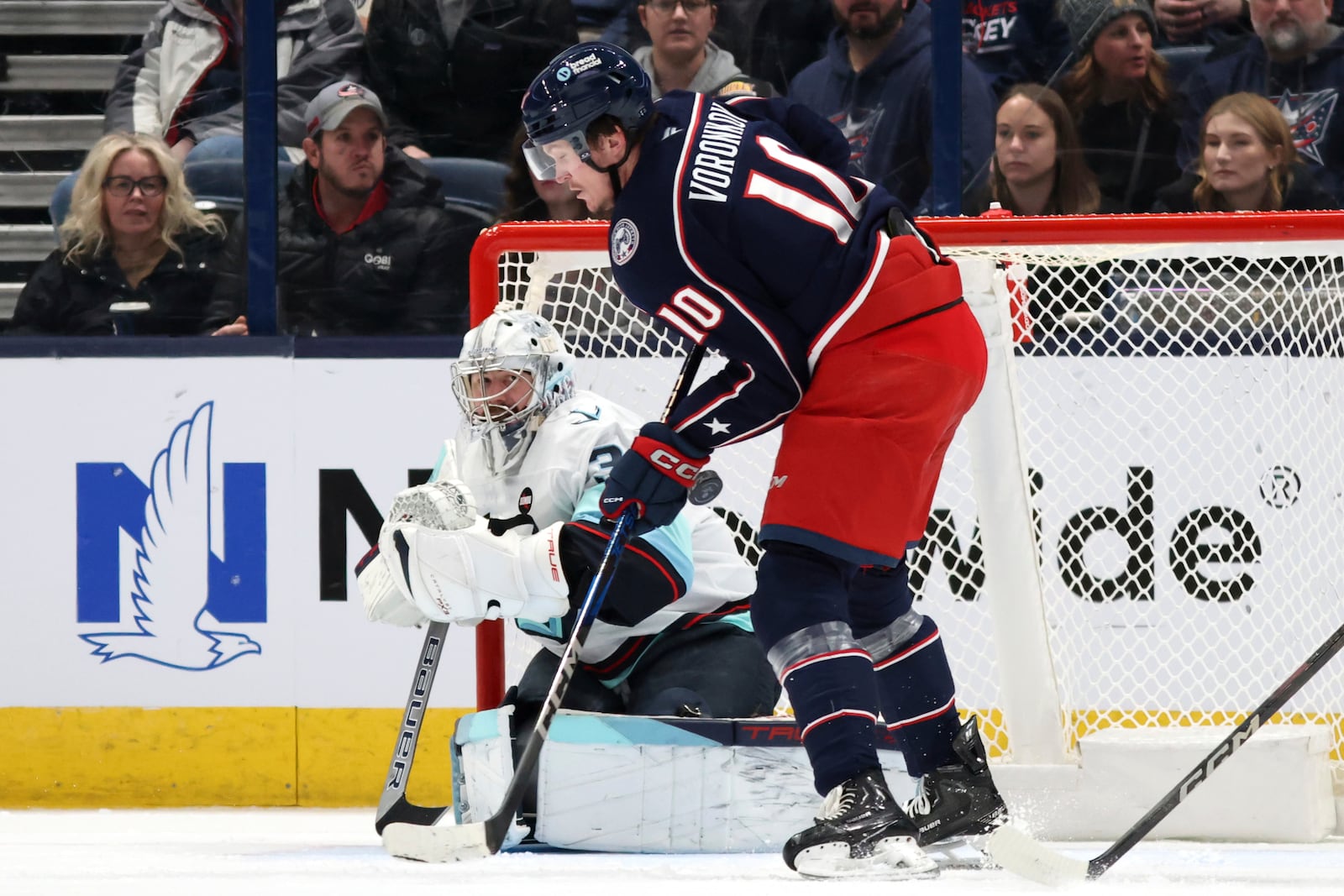 Seattle Kraken goalie Philipp Grubauer, left, makes a stop in front of Columbus Blue Jackets forward Dmitri Voronkov, right, during the first period of an NHL hockey game in Columbus, Ohio, Thursday, Jan. 9, 2025. (AP Photo/Paul Vernon)