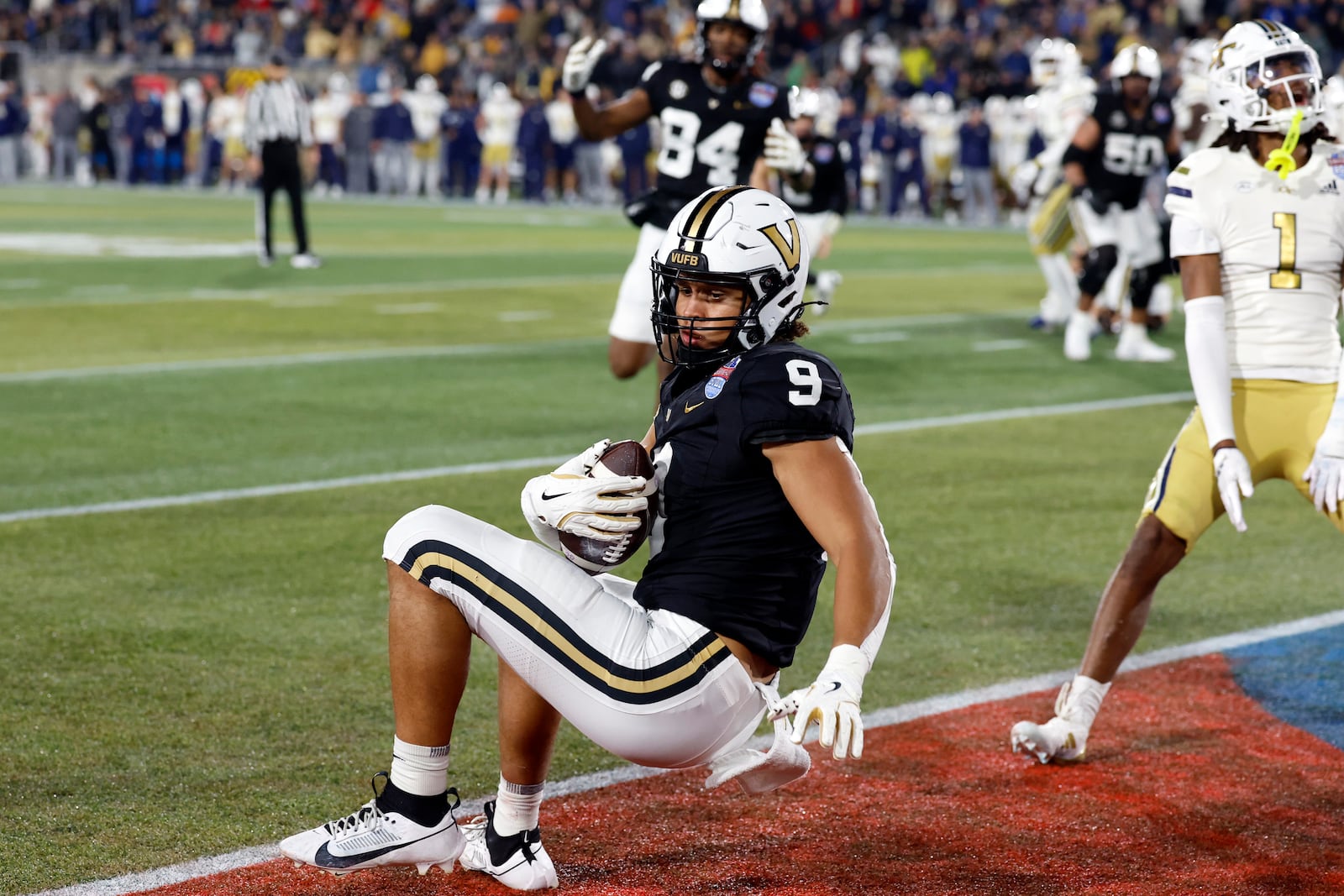 Vanderbilt tight end Eli Stowers (9) catches a pass for a touchdown against Georgia Tech during the second half of the Birmingham Bowl NCAA college football game, Friday, Dec. 27, 2024, in Birmingham, Ala. (AP Photo/Butch Dill)