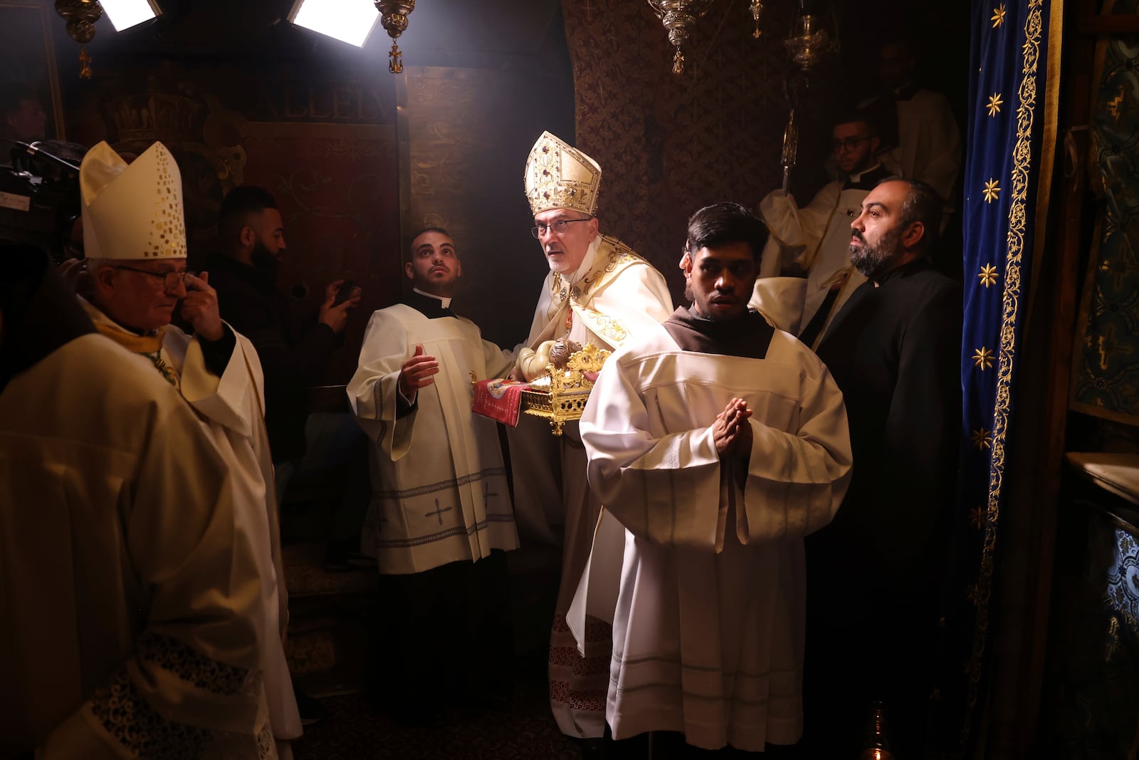 Latin Patriarch Pierbattista Pizzaballa leads the Christmas midnight Mass at the Church of the Nativity traditionally believed to be the birthplace of Jesus, in the West Bank city of Bethlehem, Wednesday Dec. 25, 2024. (Alaa Badarneh/Pool via EPA)