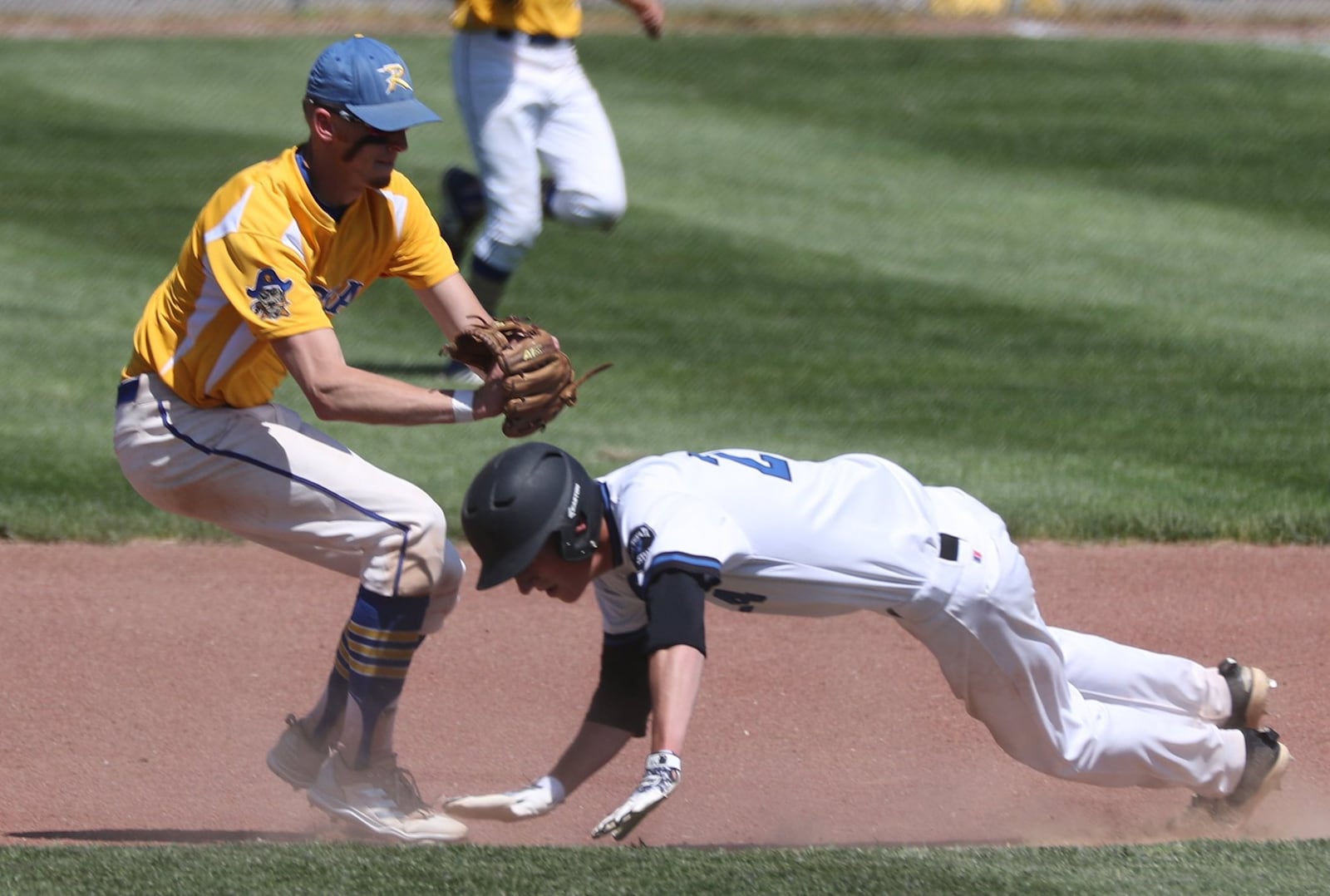 Russia’s Hunter Cohee runs down Cincinnati Christian’s Mitchell Smith between first and second base during Thursday’s Division IV regional semifinal at Carleton Davidson Stadium in Springfield. BILL LACKEY/STAFF