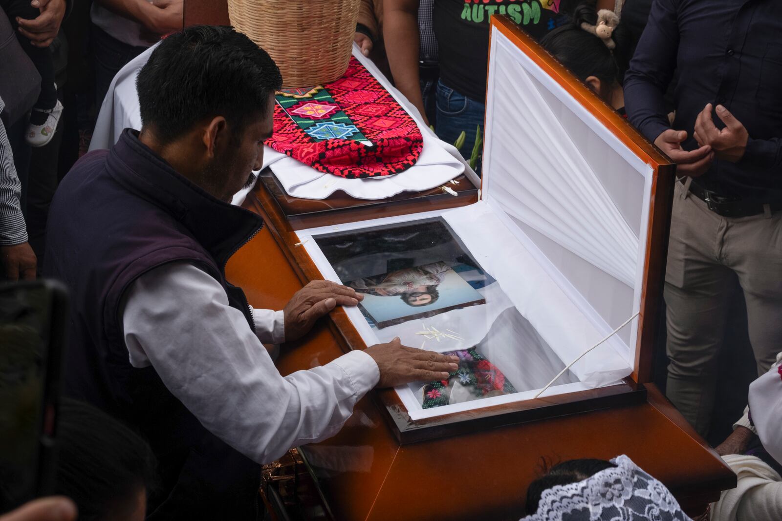 A neighbor pays his final respects to slain Catholic priest and activist Marcelo Pérez during his burial service at the church of San Andrés Larráinzar, Chiapas state, Mexico, Tuesday, Oct. 22, 2024. (AP Photo/Isabel Mateos)