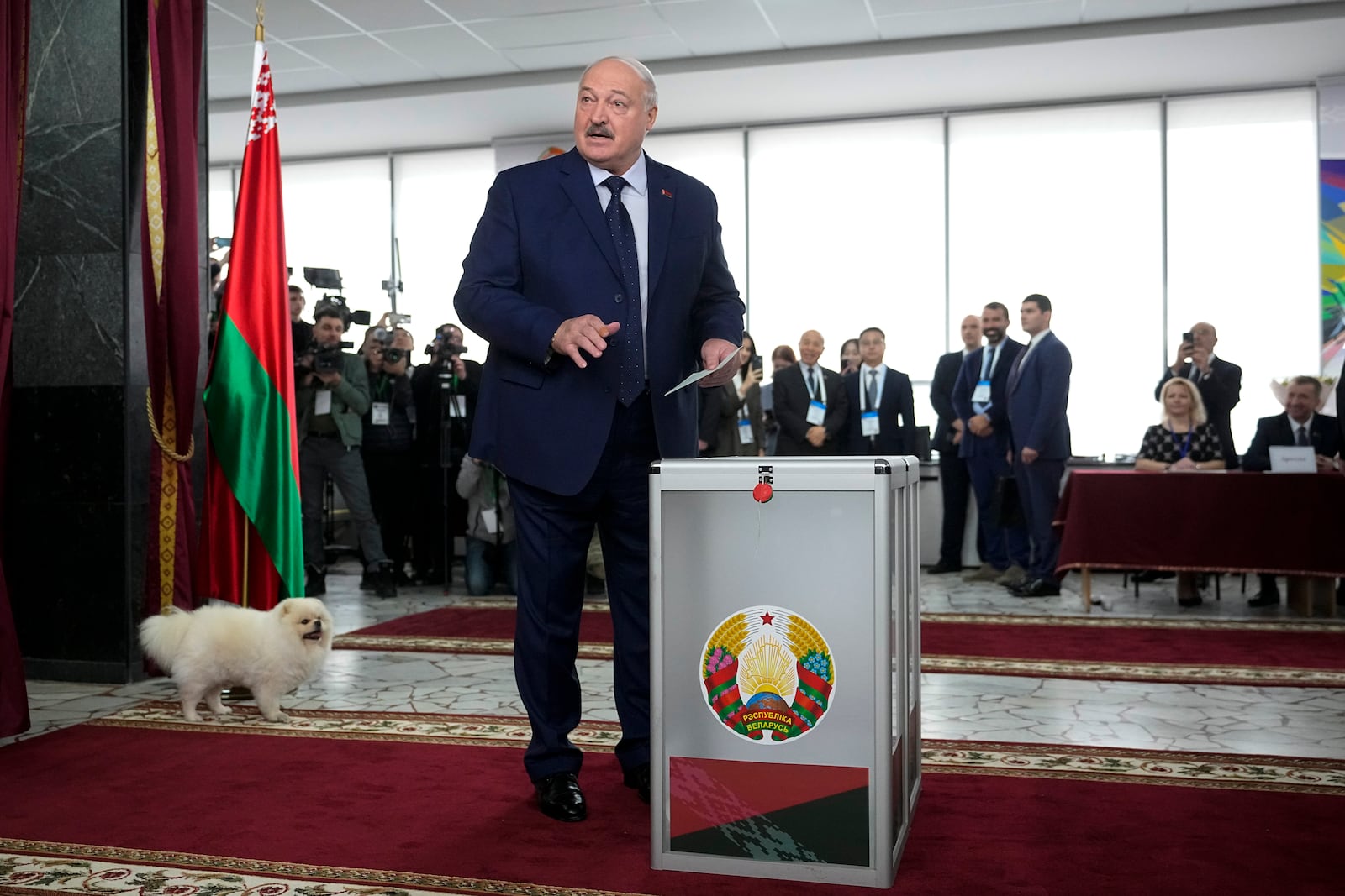 Belarusian President Alexander Lukashenko speaks to journalists as he casts his ballot at a polling site during voting in presidential elections in Minsk, Belarus, Sunday, Jan. 26, 2025. (AP Photo/Pavel Bednyakov)