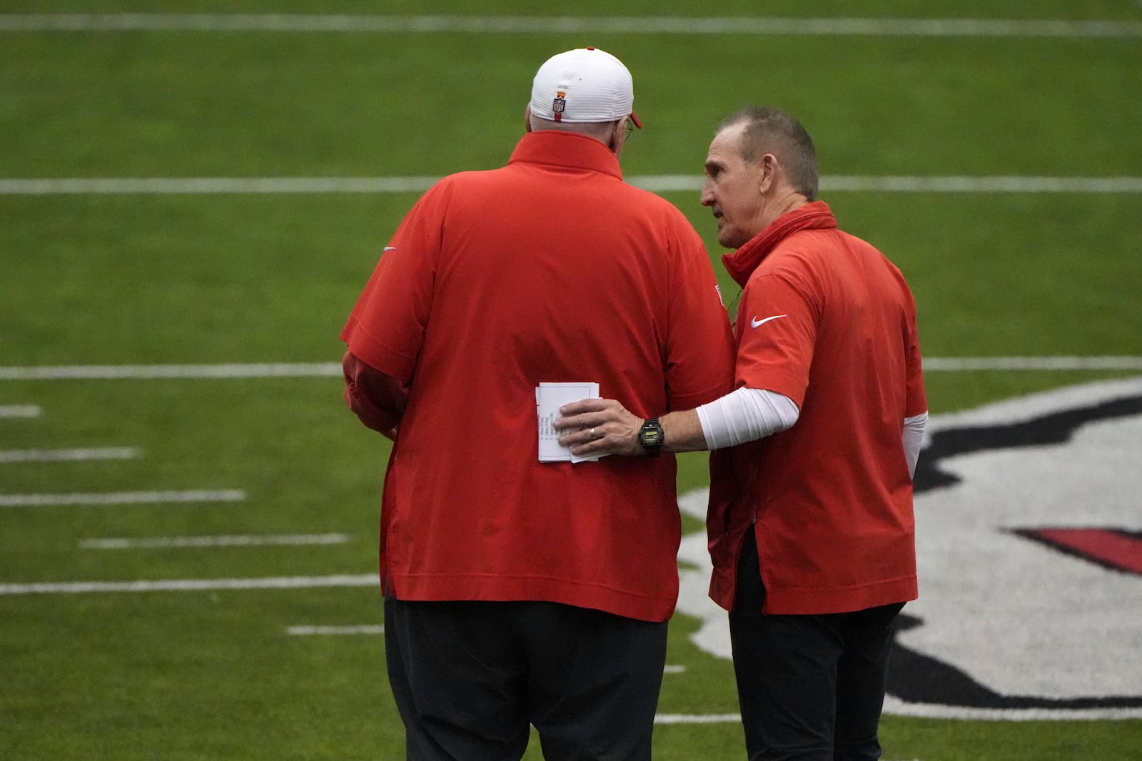 Kansas City Chiefs head coach Andy Reid, left, and Kansas City Chiefs defensive coordinator Steve Spagnuolo talk during the team's NFL football practice Thursday, Jan. 23, 2025, in Kansas City, Mo. (AP Photo/Charlie Riedel)