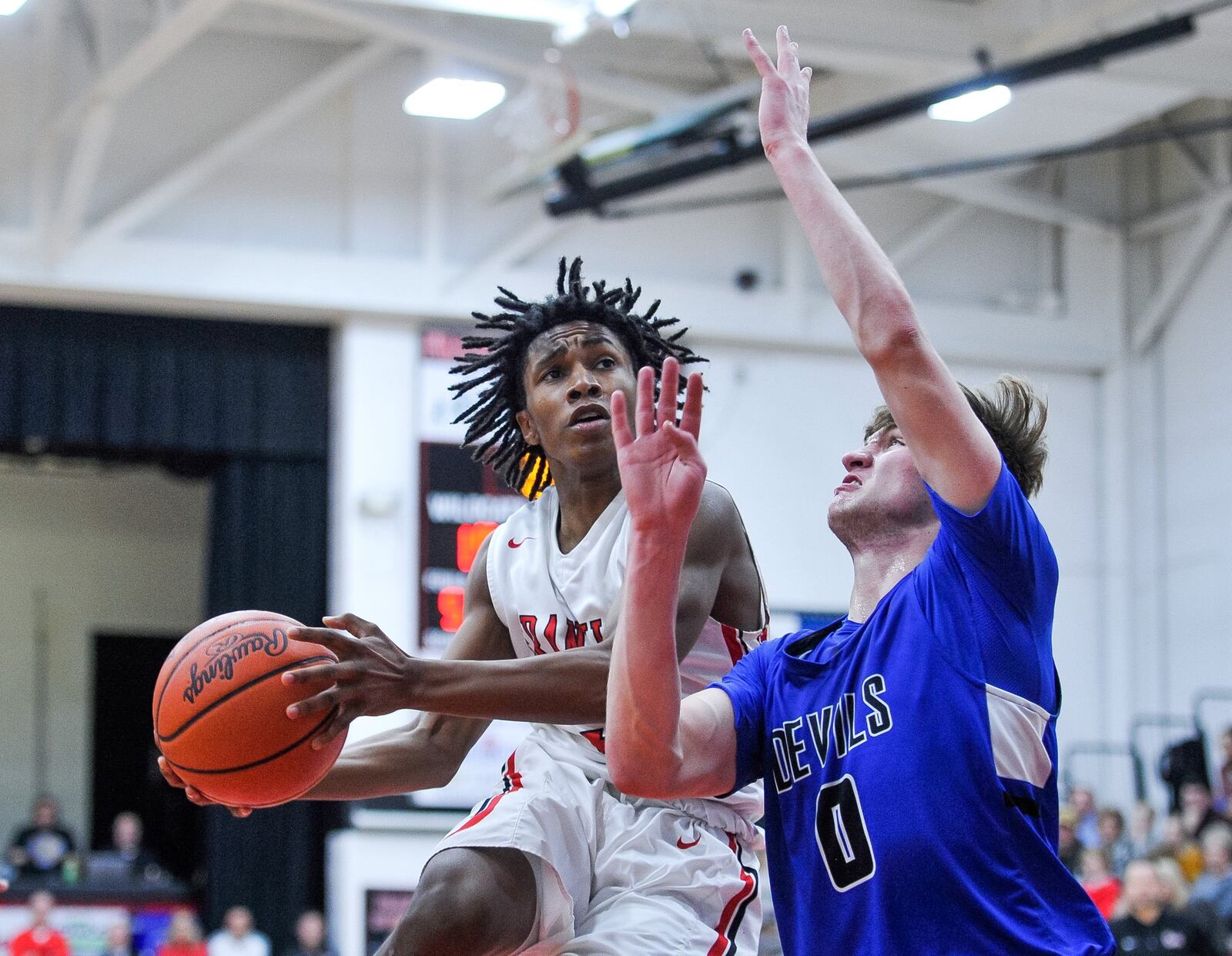 Franklin’s Savon O’Neal goes up for a shot defended by Brookville’s Jacob Gudorf during Friday night’s game at Darrell Hedric Gym in Franklin. The host Wildcats won 72-68 in overtime. NICK GRAHAM/STAFF