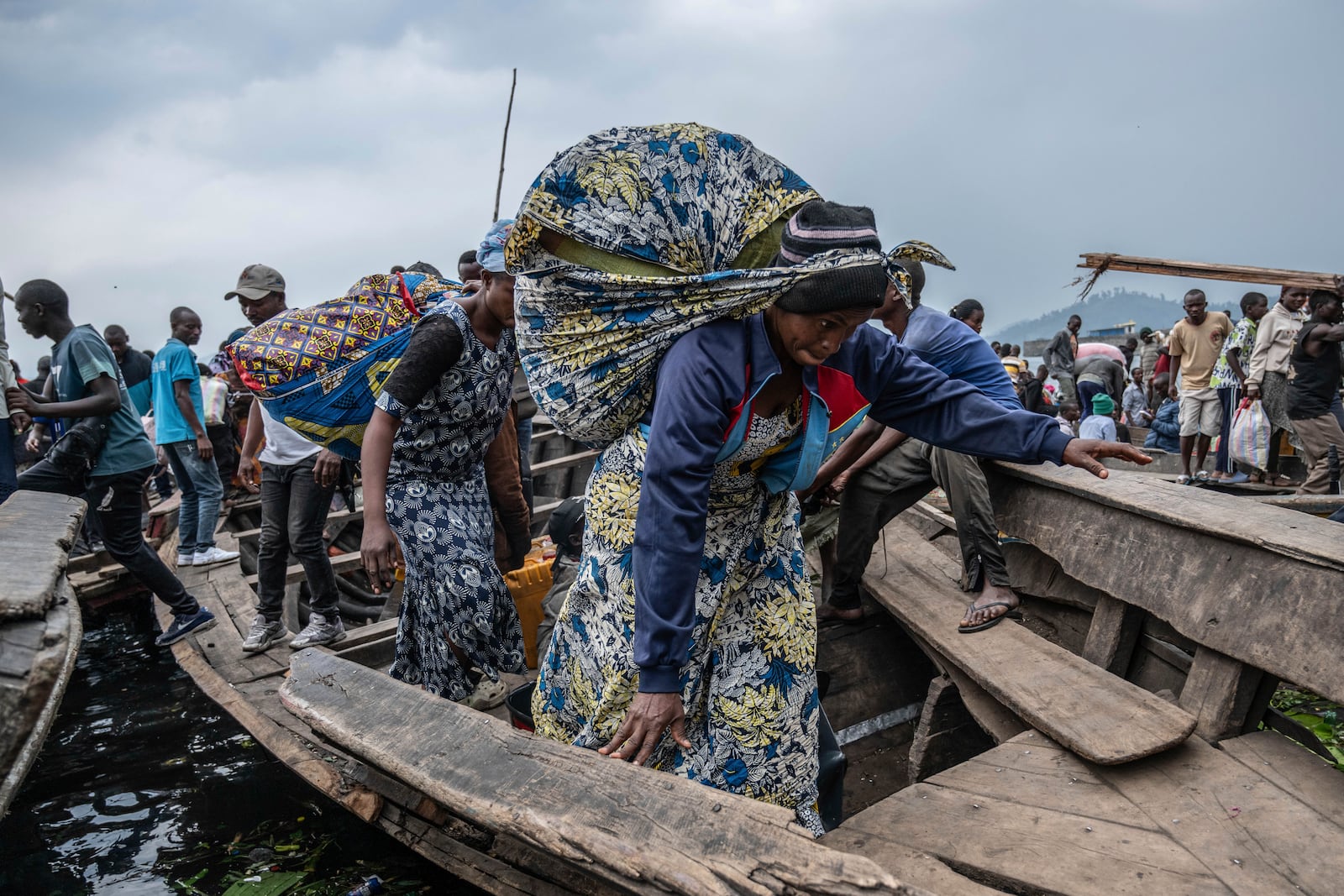 People fleeing M-23 rebel advances arrive by boat in Goma, Democratic Republic of the Congo, Wednesday, Jan. 22, 2025. (AP Photo/Moses Sawasawa)