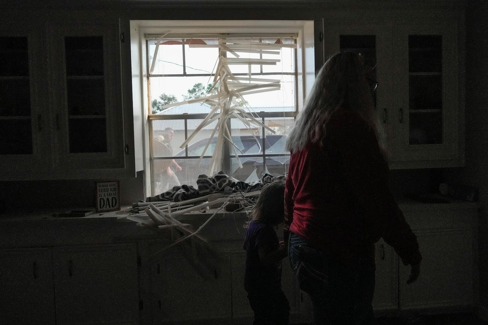 Alyssa Duncin, 26, walks with her daughter Kingsley Duncin, 3, through the family home just after it was destroyed by a tornado that hit nearby on Saturday, Dec. 28, 2024, in Alvin, Texas. (Raquel Natalicchio/Houston Chronicle via AP)