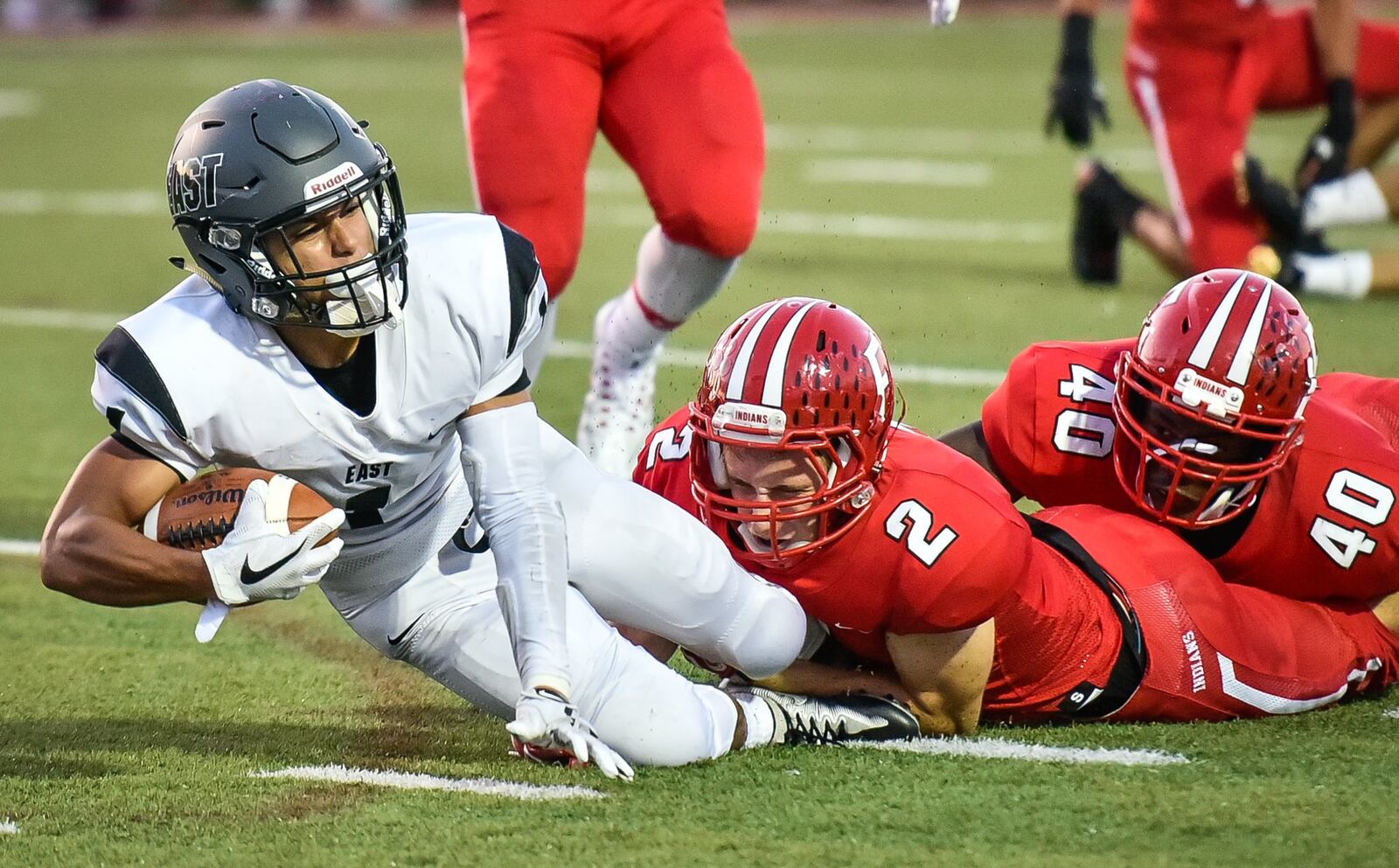 Fairfield’s Kyle Schimpf (2) and Nashon Bell (40) take down Lakota East’s Jeff Garcia during Friday night’s game at Fairfield Stadium. NICK GRAHAM/STAFF