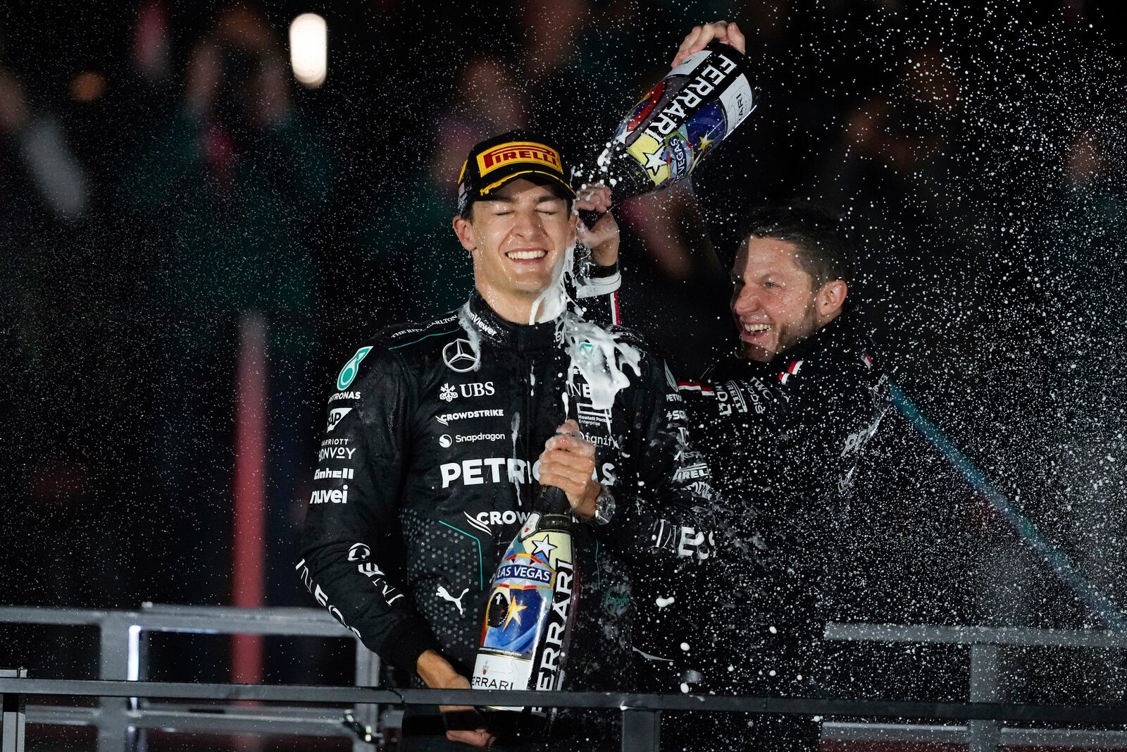 Mercedes driver George Russell, of Britain, celebrates on the podium after winning the F1 Las Vegas Grand Prix auto race, Sunday, Nov. 24, 2024, in Las Vegas. (AP Photo/Matt York)