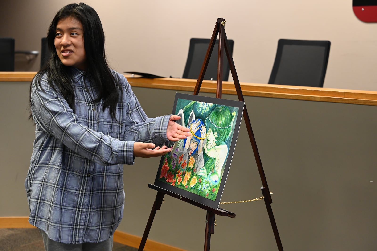 Newly minted Fairfield High School graduate Donna Julian-Mendoza was awarded an art scholarship by the Fairfield Rotary Club. The recognition was at the service organization's annual recognition of Fairfield students and educators, which was on May 16, 2024. Pictured is Julian-Mendoza talking about her untitled piece. MICHAEL D. PITMAN/STAFF