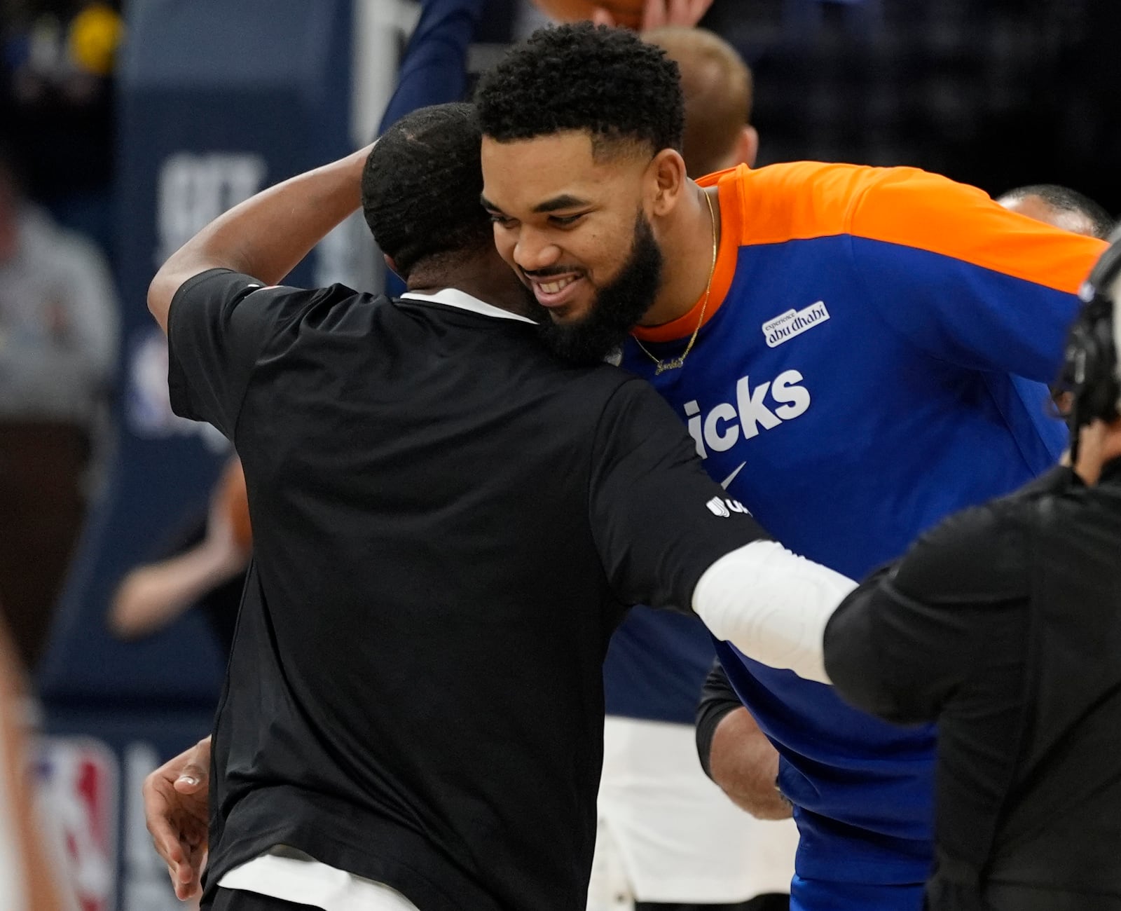 Minnesota Timberwolves guard Mike Conley, left, and New York Knicks center Karl-Anthony Towns, right, hug before an NBA basketball game Thursday, Dec. 19, 2024, in Minneapolis. (AP Photo/Abbie Parr)