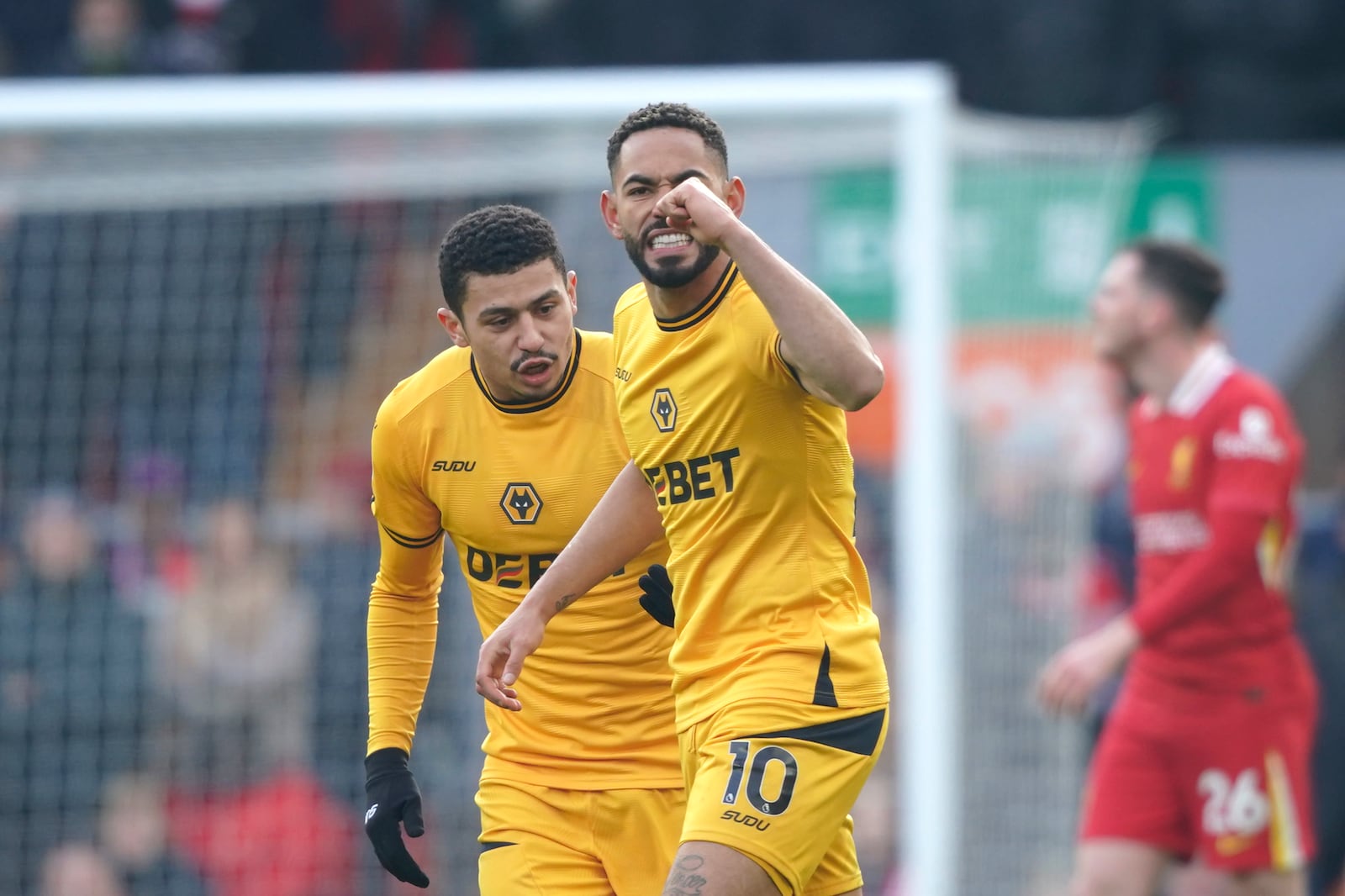 Wolverhampton Wanderers' Matheus Cunha, centre, celebrates after scoring his side's opening goal during the English Premier League soccer match between Liverpool and Wolverhampton Wanderers at Anfield Stadium in Liverpool, Sunday, Feb. 16, 2025. (AP Photo/Ian Hodgson)