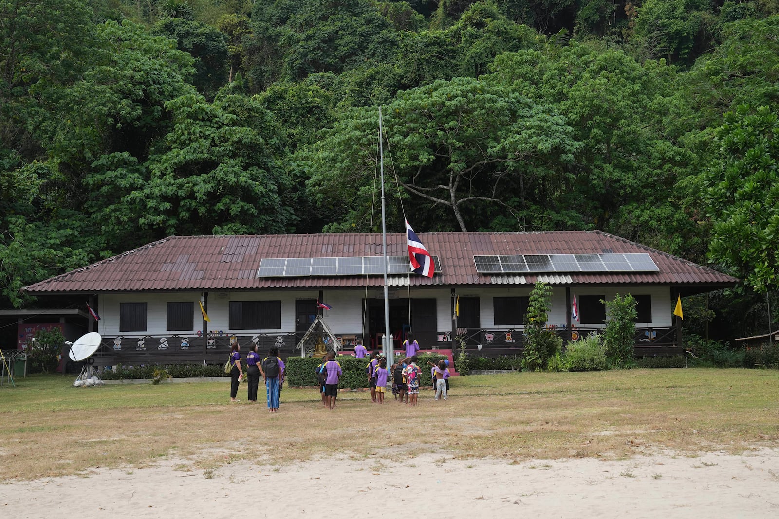 Moken students sing Thailand's national anthem at a learning center at Surin Islands in Phang Nga Province, Thailand, Thursday, Dec. 12, 2024. (AP Photo/Sakchai Lalit)