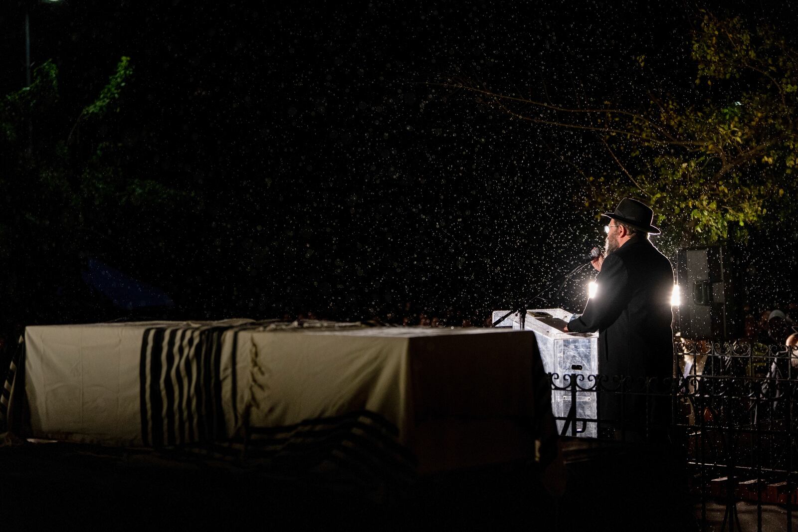 A rabbi delivers an eulogy next to the coffin containing the remains of Israeli-Moldovan rabbi Zvi Kogan in Kfar Chabad, Israel, Monday Nov. 25, 2024. Kogan, 28, an ultra-Orthodox rabbi, was killed last week in Dubai where he ran a kosher grocery store. Israelis have flocked for commerce and tourism since the two countries forged diplomatic ties in the 2020 Abraham Accords.(AP Photo/Ohad Zwigenberg)