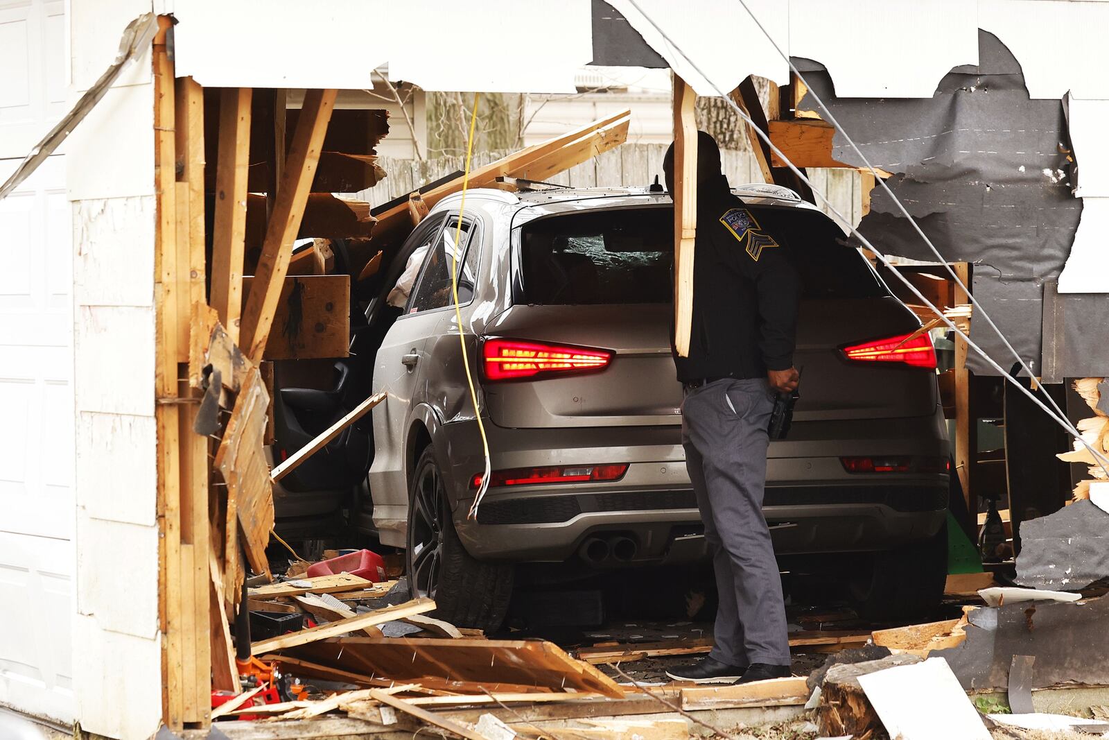 A suspect fled from Middletown police Thursday and crashed into a detached garage in the alley behind Beech Street. NICK GRAHAM/STAFF