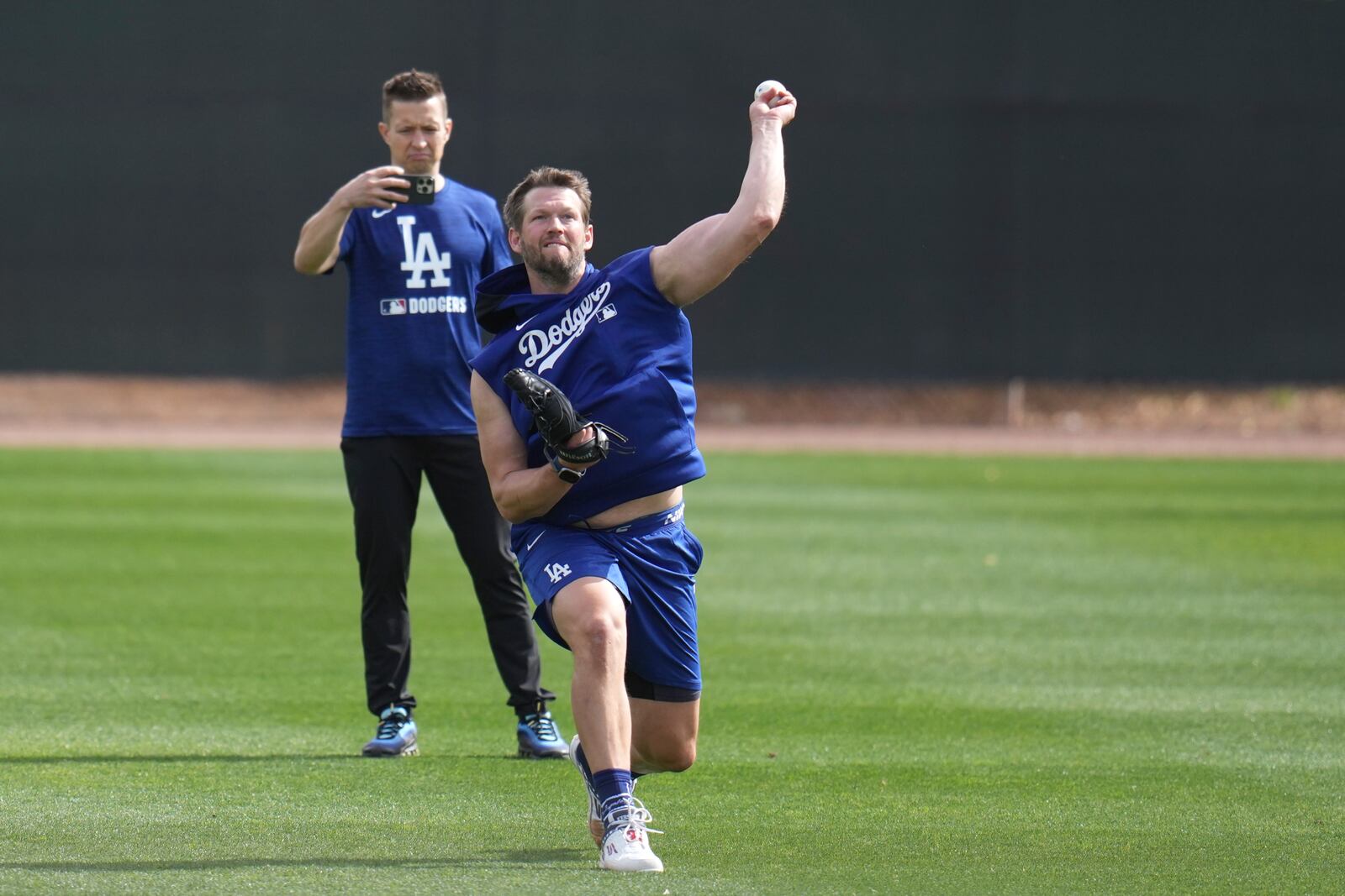 Los Angeles Dodgers pitcher Clayton Kershaw warms up at the Dodgers baseball spring training facility, Tuesday, Feb. 11, 2025, in Phoenix. (AP Photo/Ross D. Franklin)