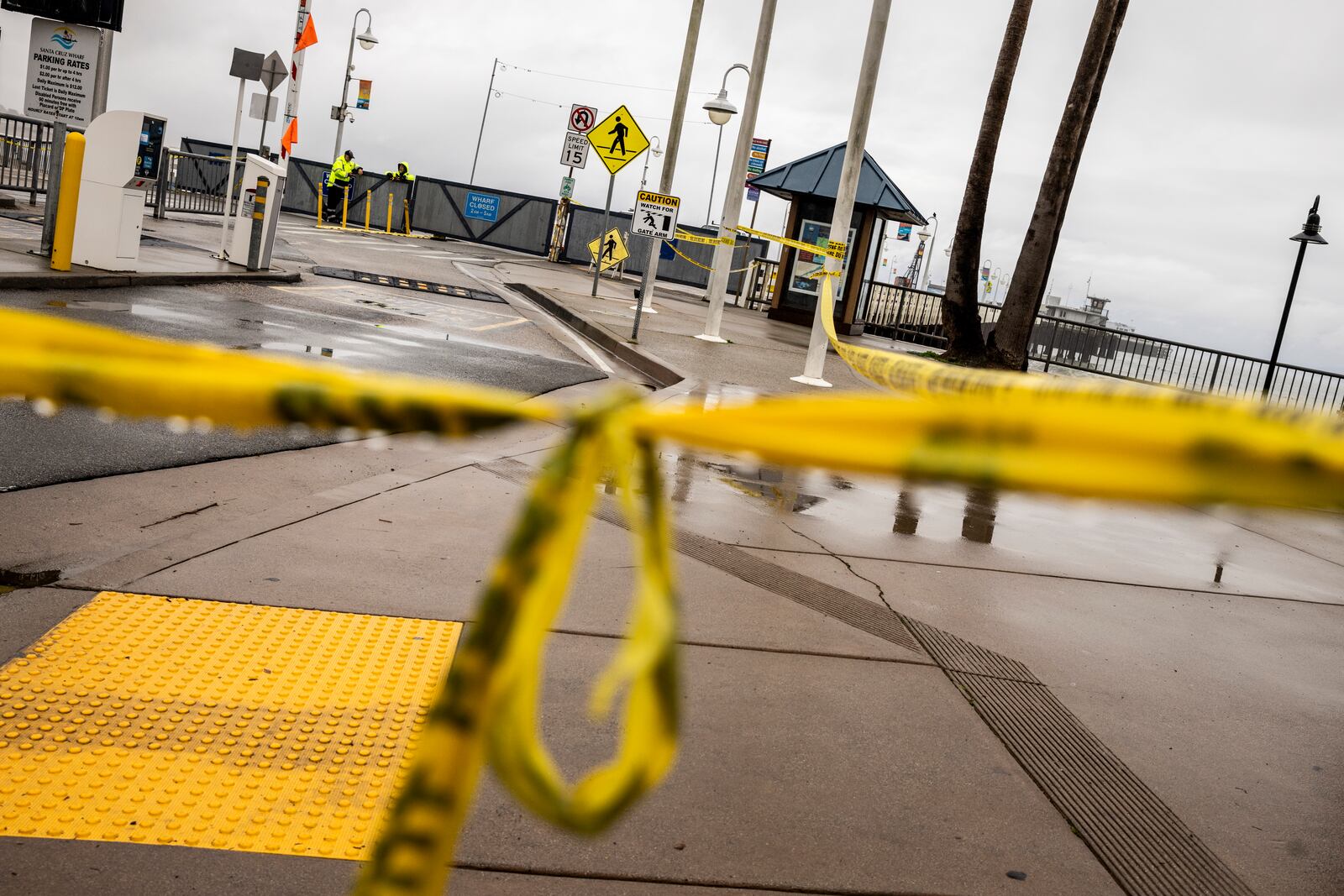 Caution tape hangs near the entrance of the closed Santa Cruz Wharf after a section of the wharf collapsed into the Pacific Ocean amidst heavy surf Monday in Santa Cruz, Calif., Tuesday, Dec. 24, 2024. (Stephen Lam/San Francisco Chronicle via AP)