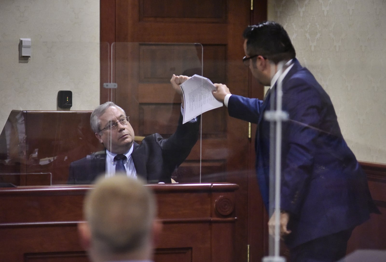 Defense attorney Frank Schiavone IV, right, questions pathologist Dr. Lee Lehman about puncture woulds during the trial of Peyton McFarland for the death of Chris Hacker Tuesday, April 20, 2021 in Butler County Common Pleas Court in Hamilton. The defense says McFarland acted in self defense when he stabbed Chris Hacker to death at their Monroe residence. NICK GRAHAM / STAFF