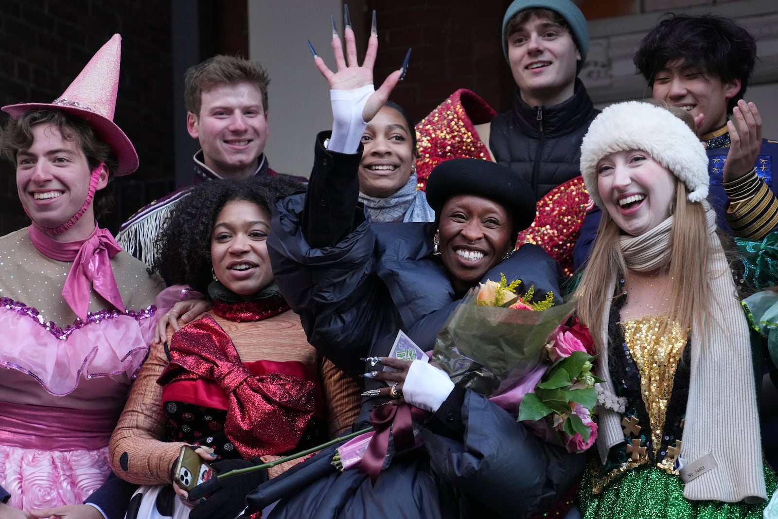 Harvard University's Hasty Pudding Theatricals Woman of the Year Cynthia Erivo waves while flanked by character actors following a parade in her honor, Wednesday, Feb. 5, 2025, in Cambridge, Mass. (AP Photo/Charles Krupa)