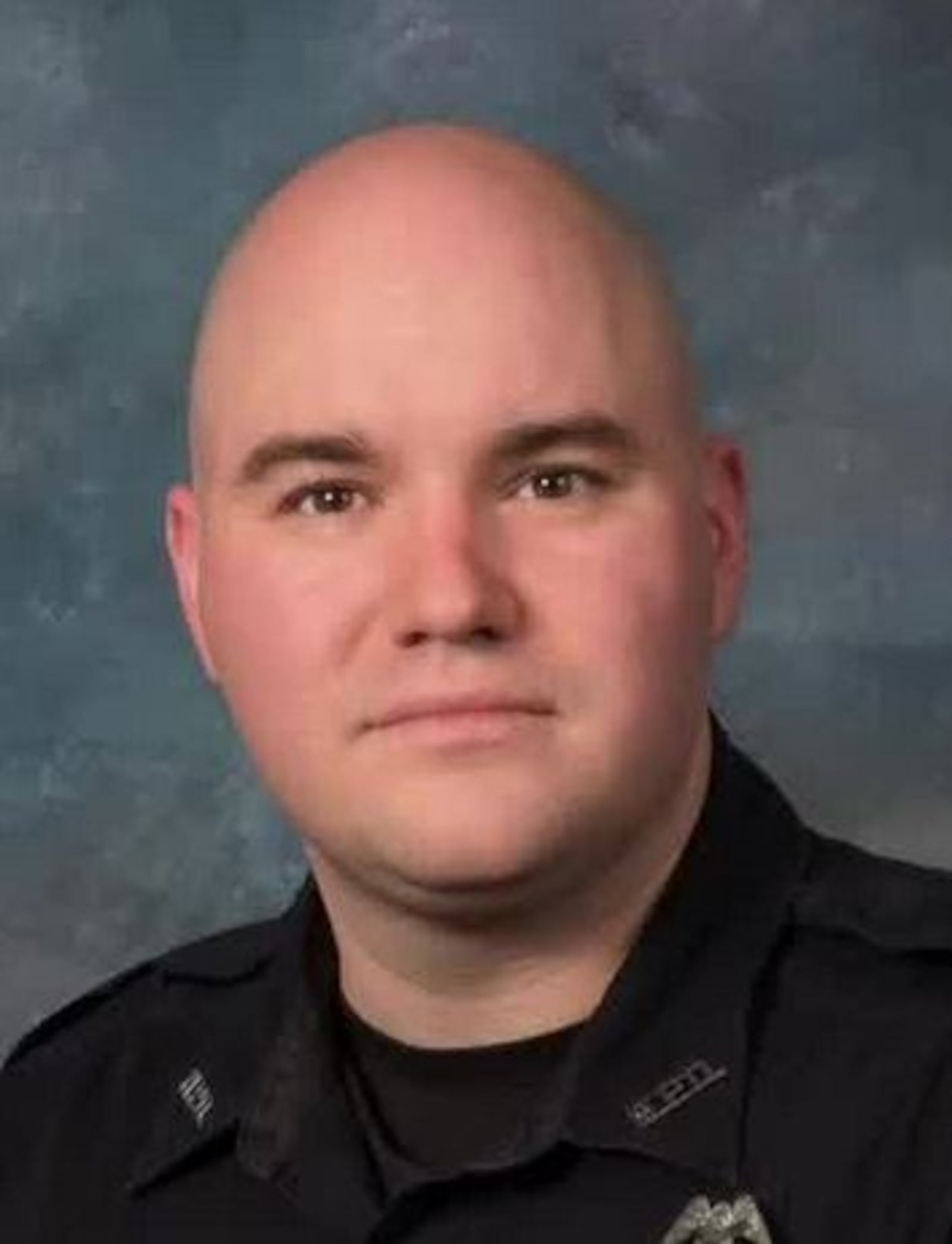 Middletown officer Steve Crank is being credited with helping rescue a woman who was trapped inside a building house.