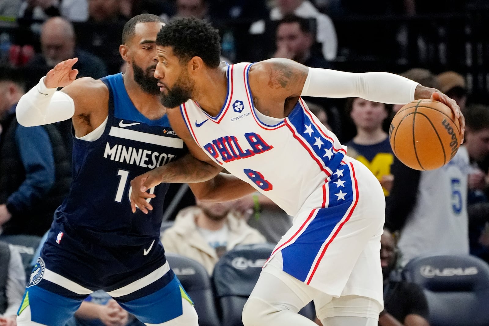 Philadelphia 76ers forward Paul George (8) works around Minnesota Timberwolves guard Mike Conley (10) in the third quarter of an NBA basketball game Tuesday, March 4, 2025, in Minneapolis. (AP Photo/Bruce Kluckhohn)